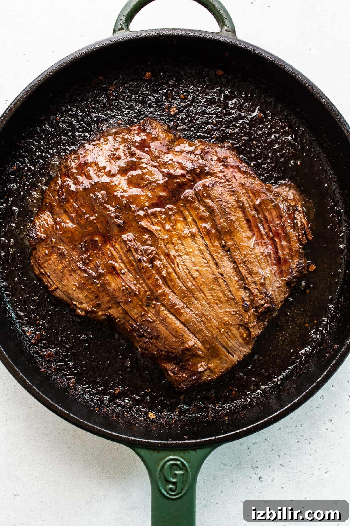Flank steak seared in a cast iron pan. Flank steak seared in a cast iron pan.