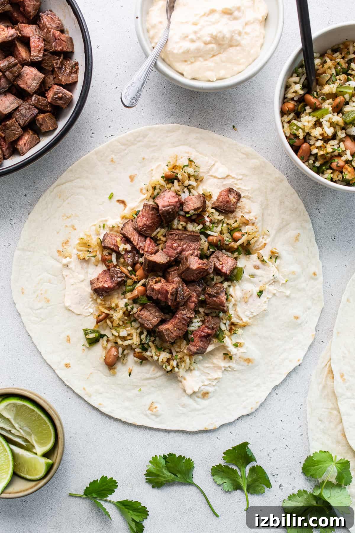 Steak burrito laid flat on a cutting board.