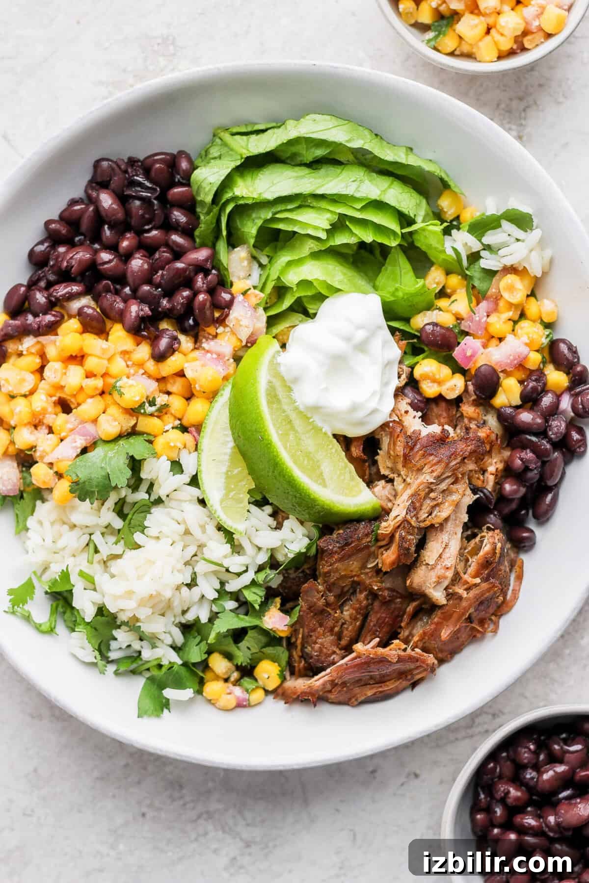 Slow Cooker Carnitas Burrito Bowls with Cilantro Lime Rice 2 burrito bowl in glass container