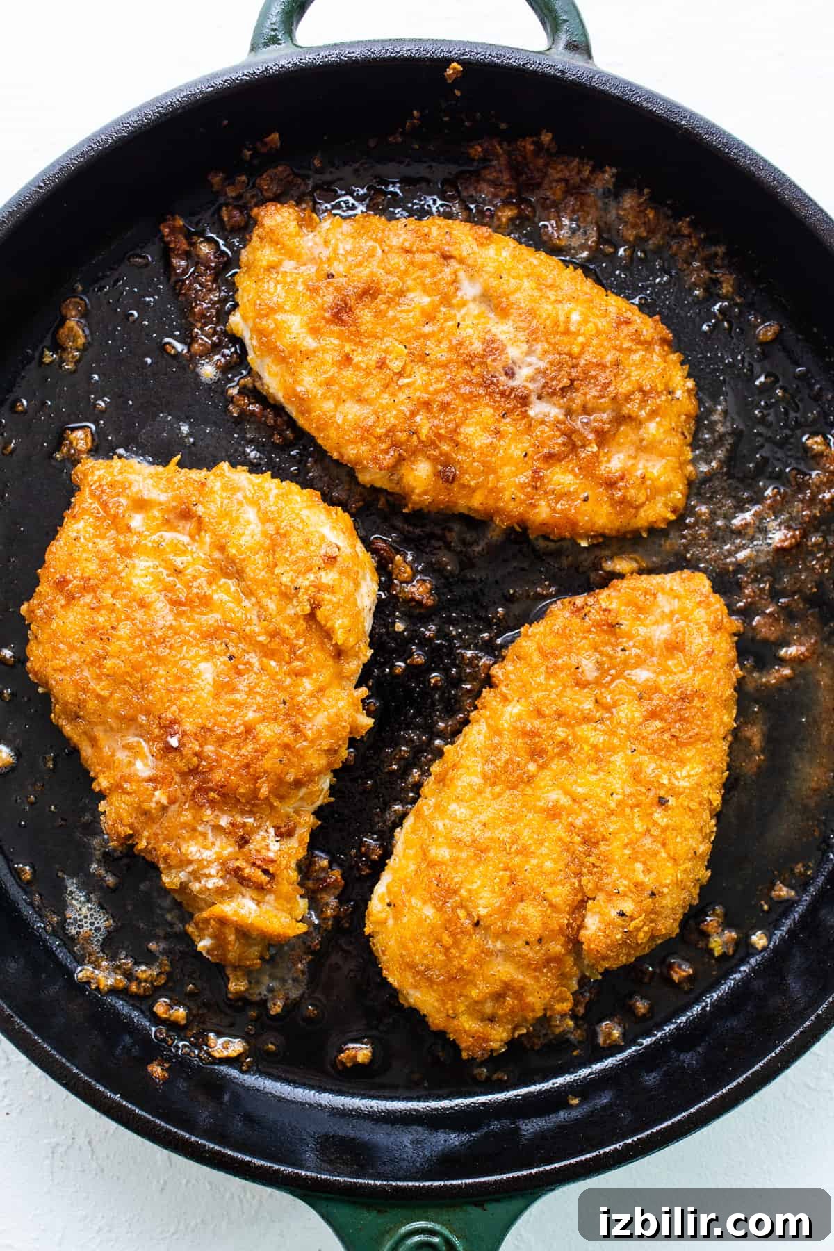 Pan-frying chicken breasts in a skillet Chicken breast in cast iron.