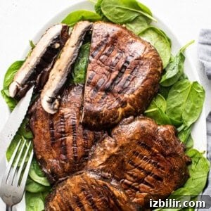 Grilled Portobello Mushroom Burgers with Balsamic Glaze 2 Grilled mushrooms and spinach on a plate.