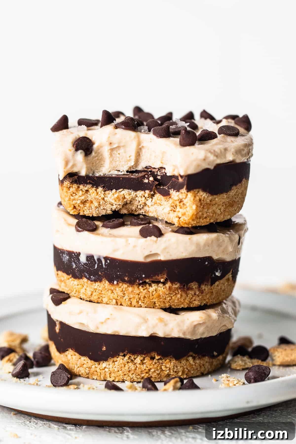 Peanut Butter Chocolate Cottage Cheese Cheesecake Cups Peanut butter chocolate cheesecake cups stacked on a plate.