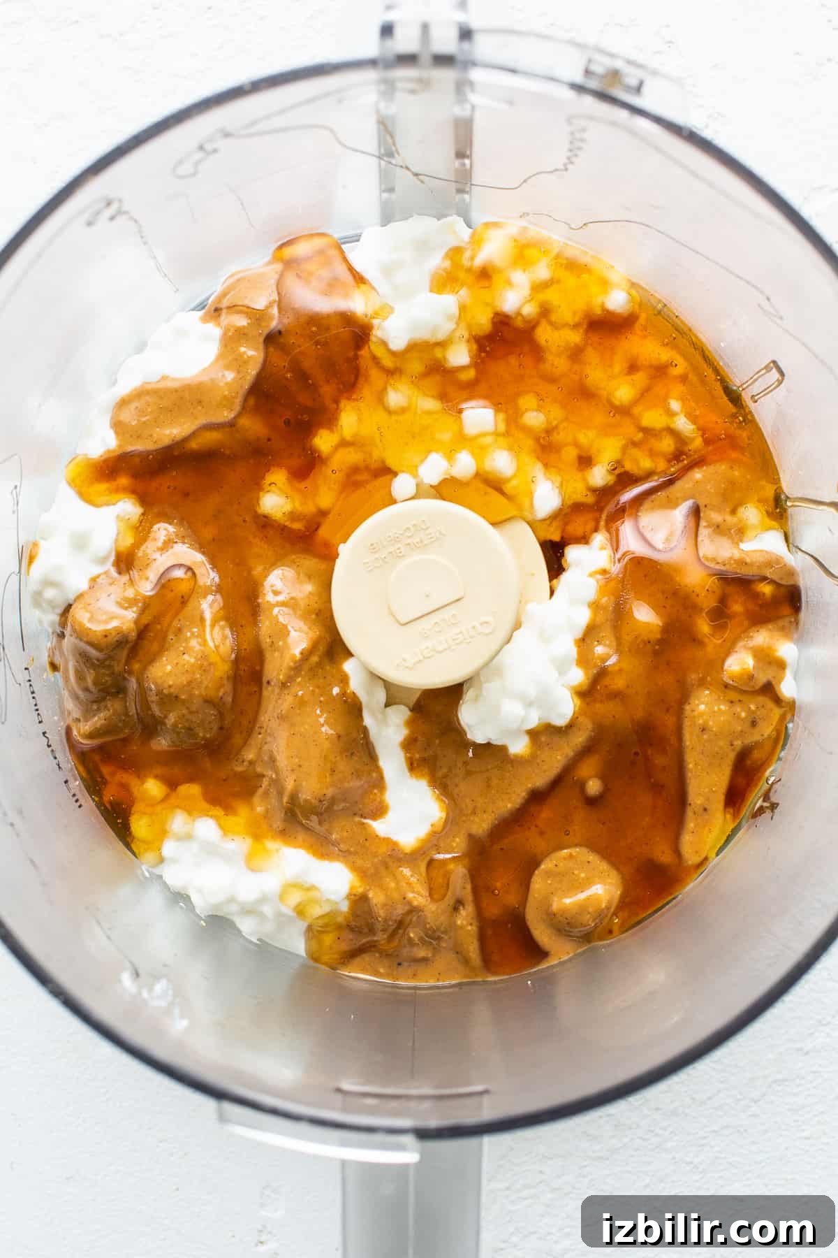 Blending cottage cheese, peanut butter and honey Cottage cheese, peanut butter and honey in a food processor.