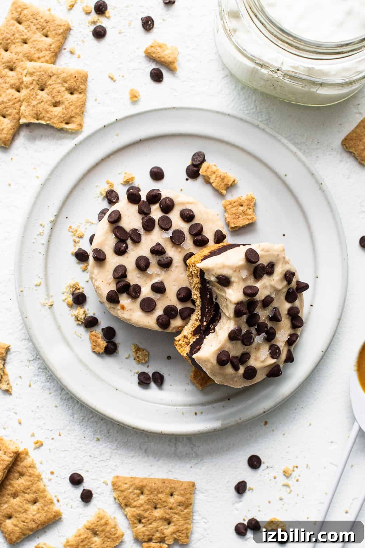 Peanut Butter Chocolate Cheesecake Cups Peanut butter chocolate cheesecake cups on a plate with a bite taken out of them.