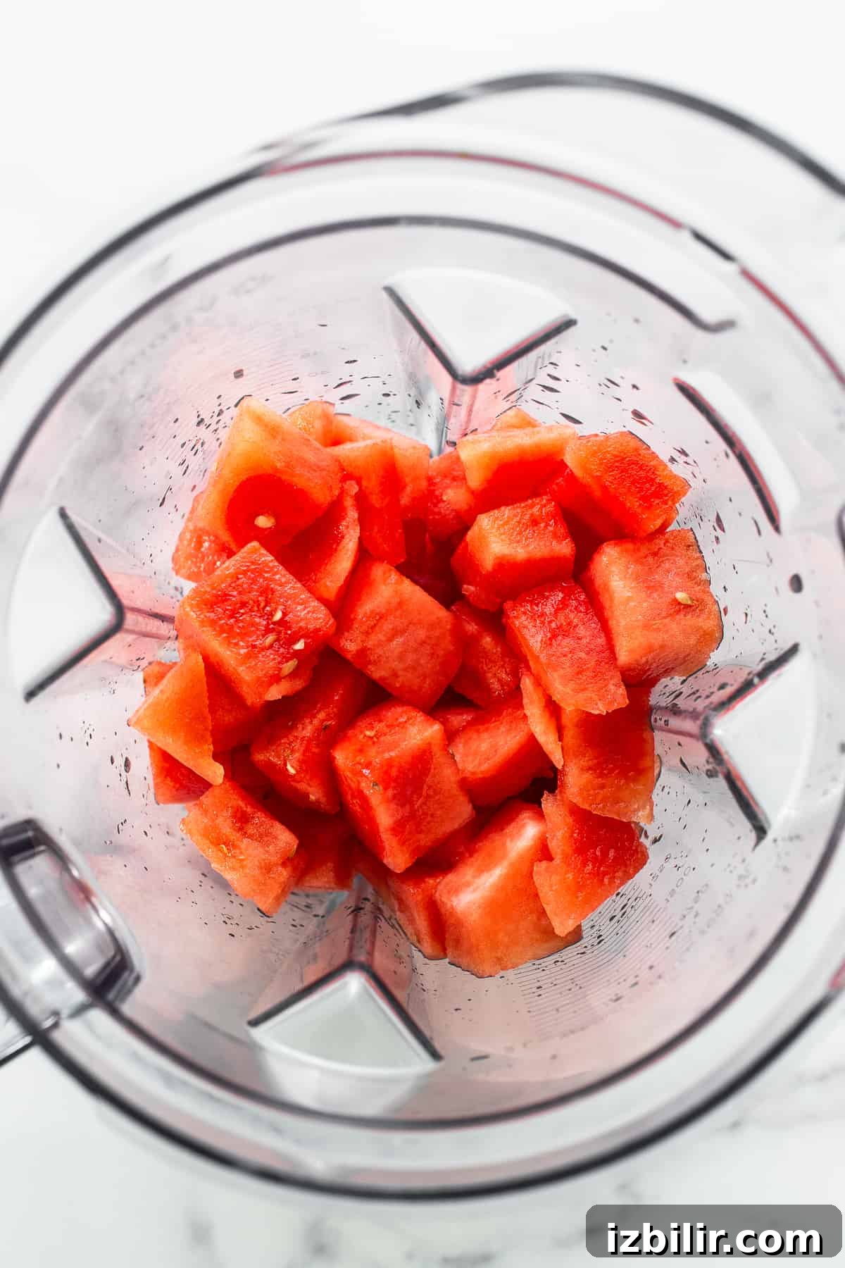 Watermelon chunks in a blender ready for blending.