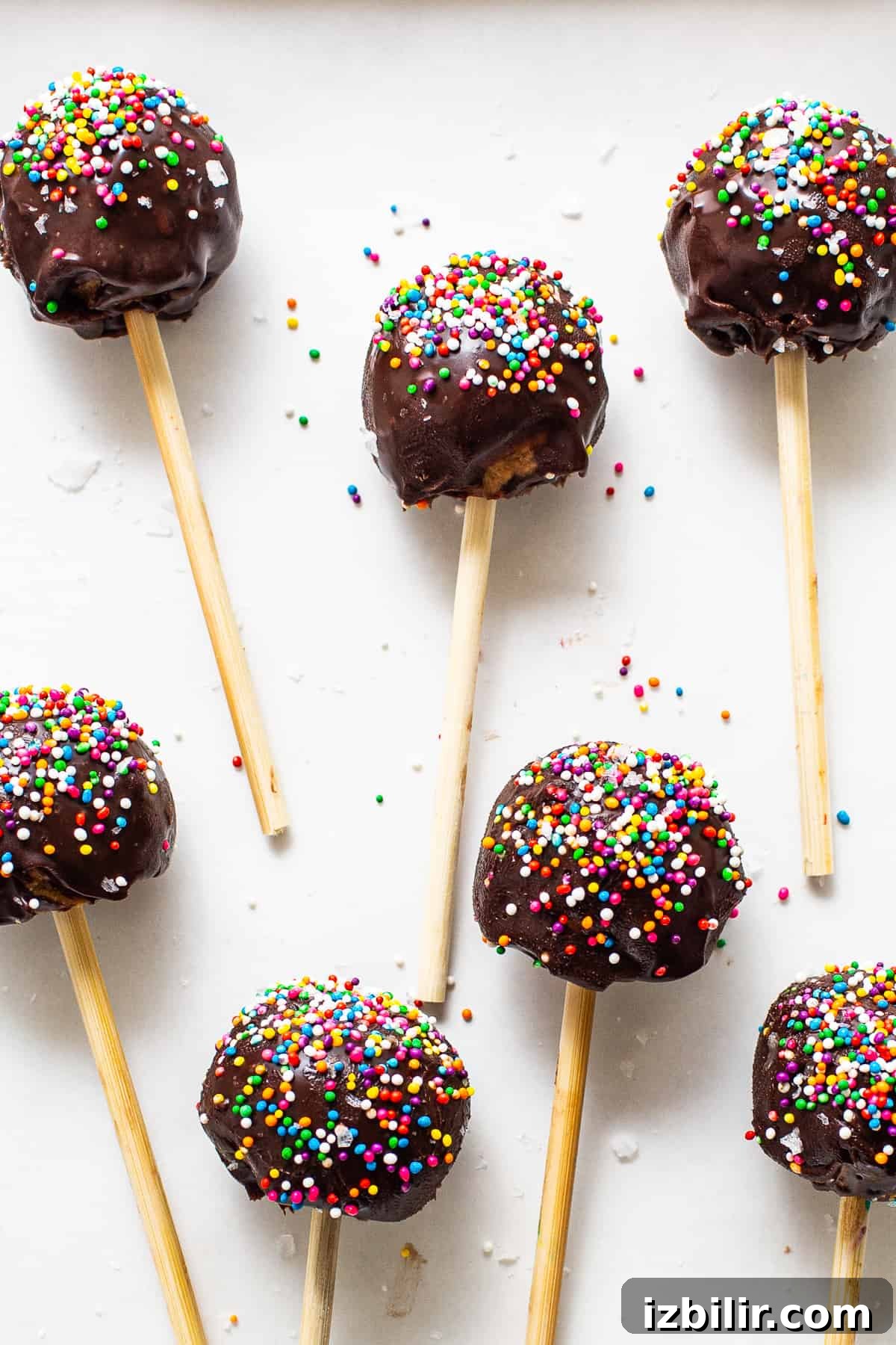 High-Protein Cake Pop Recipe 2 Protein cake pops covered in sprinkles.