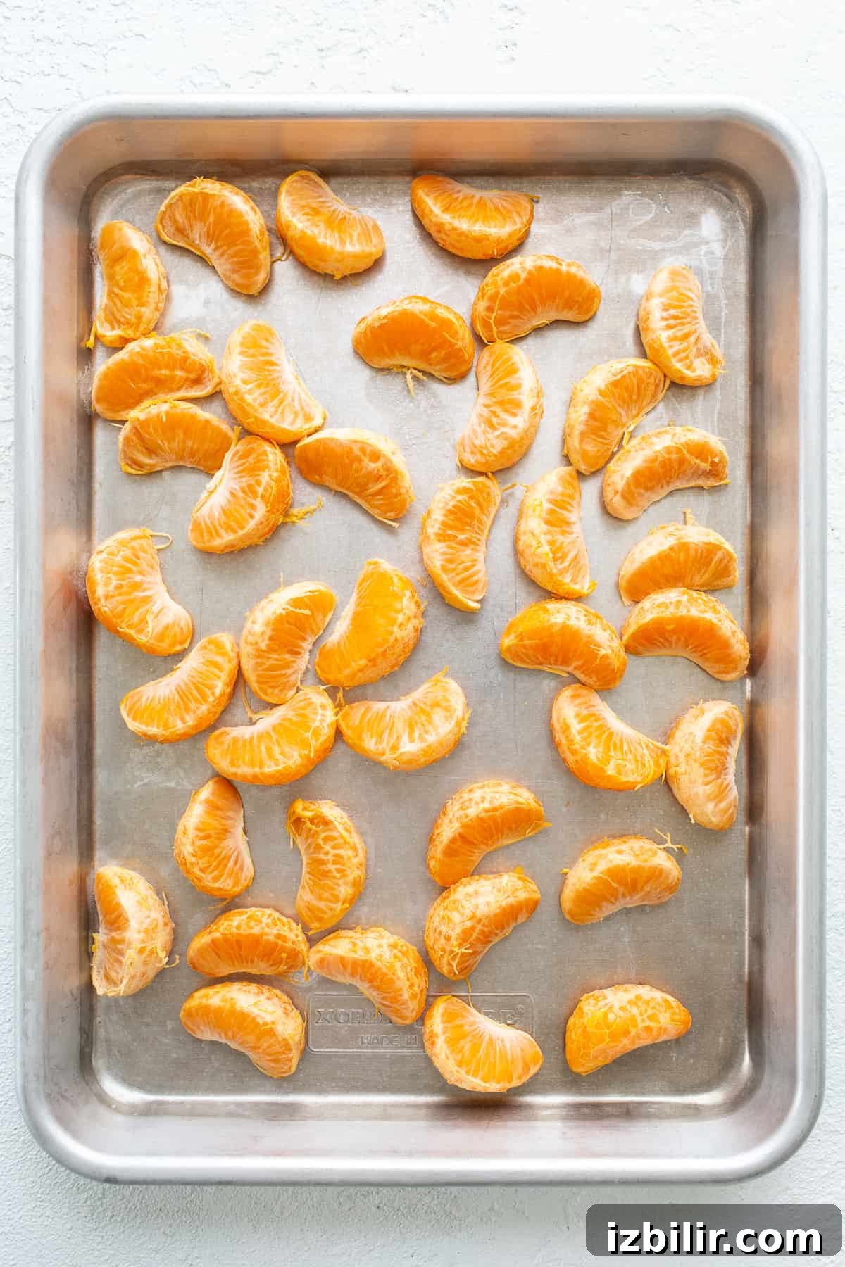 Frozen clementines on a baking sheet clementines on baking sheet.