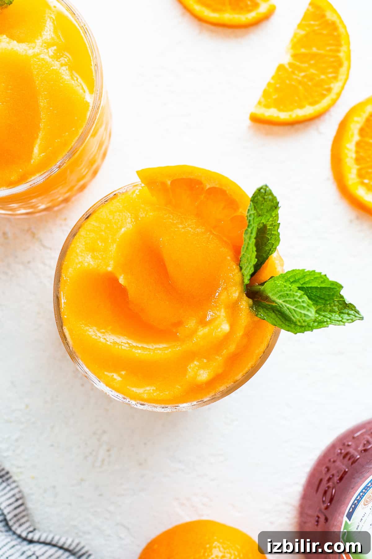 Frozen Aperol Spritz Slushie in a glass frozen aperol spritz in glass.