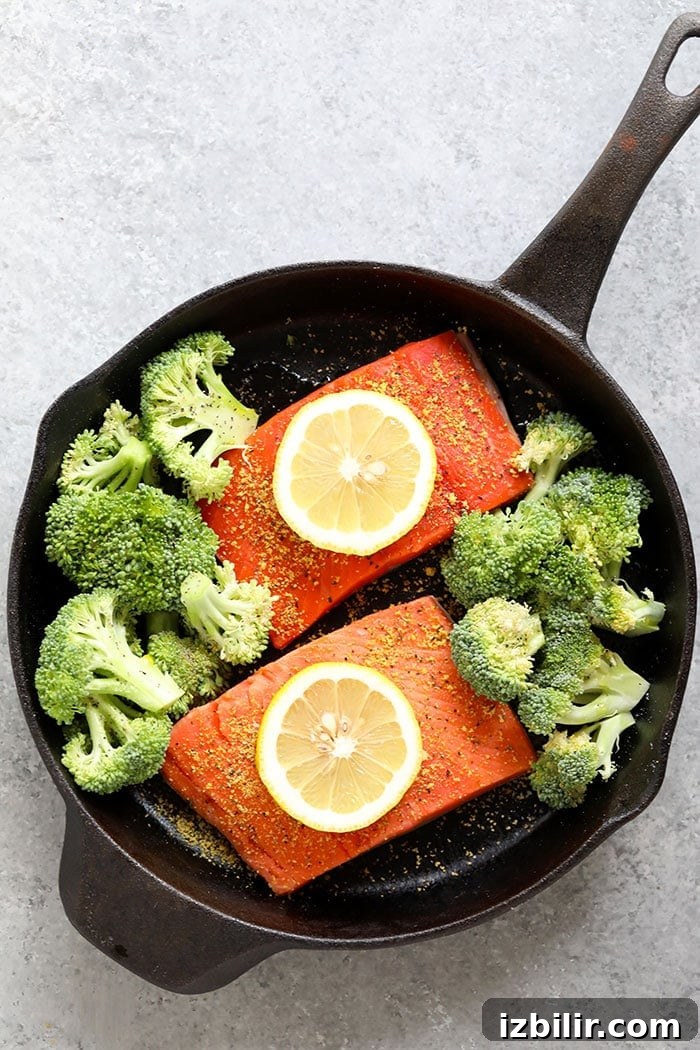 Salmon fillet with roasted broccoli and lemon wedges