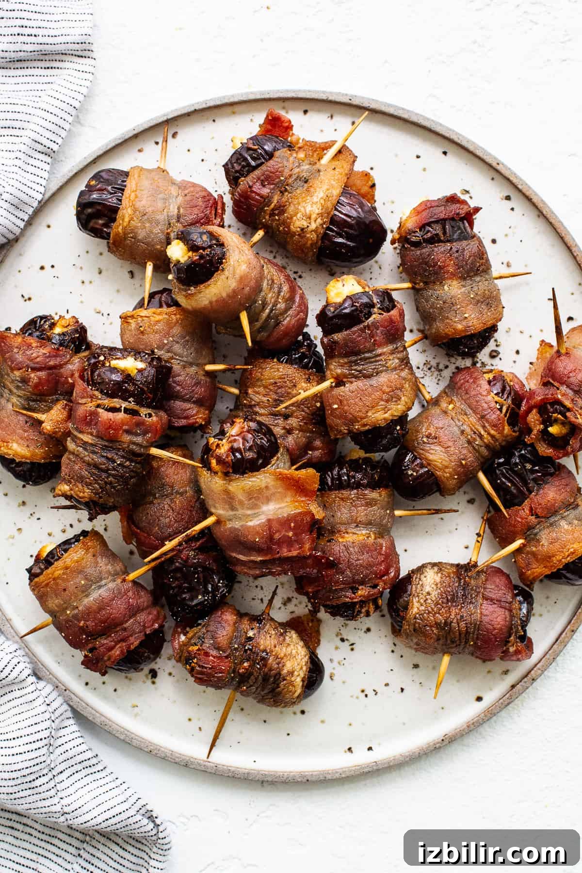 Bacon wrapped dates with goat cheese Bacon wrapped dates with goat cheese on a plate.