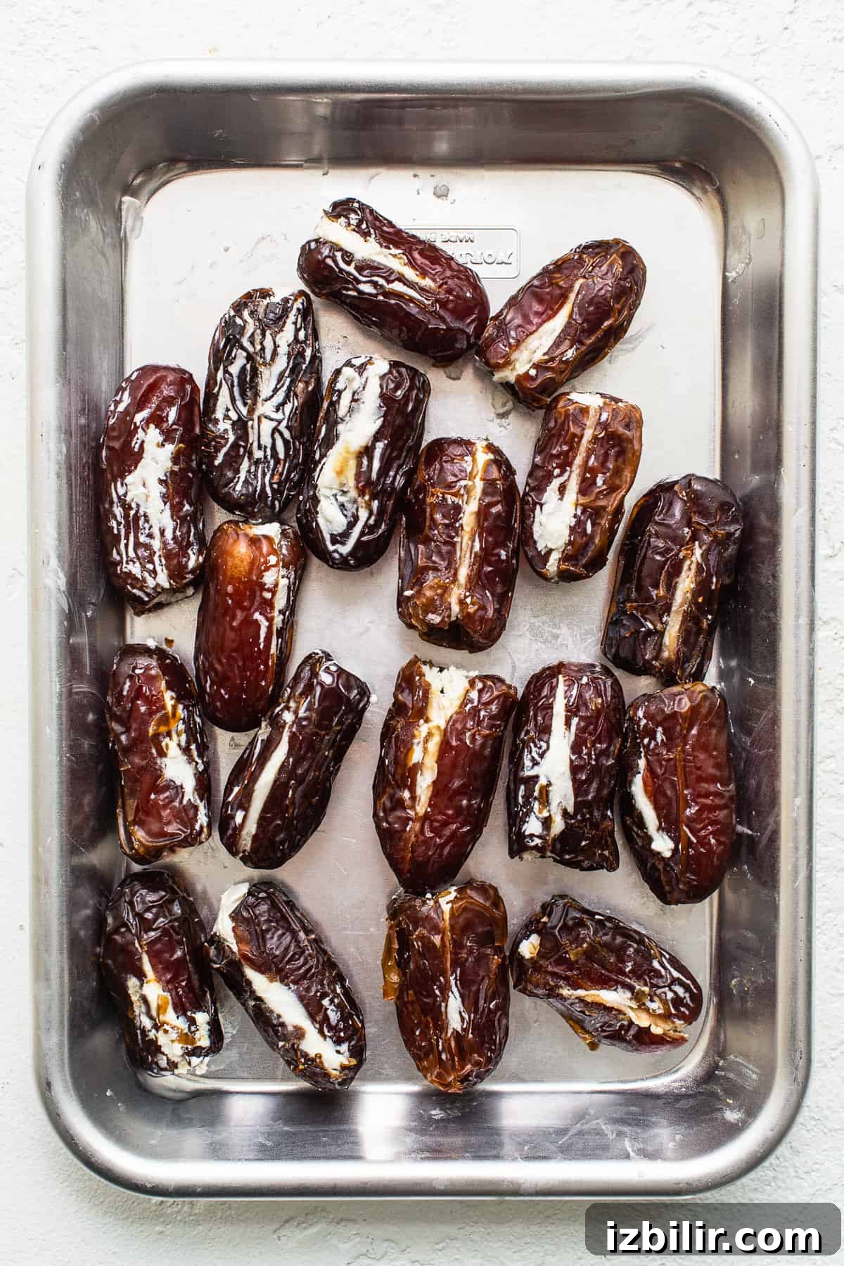 Dates stuffed with goat cheese Dates stuffed with goat cheese on a baking sheet.