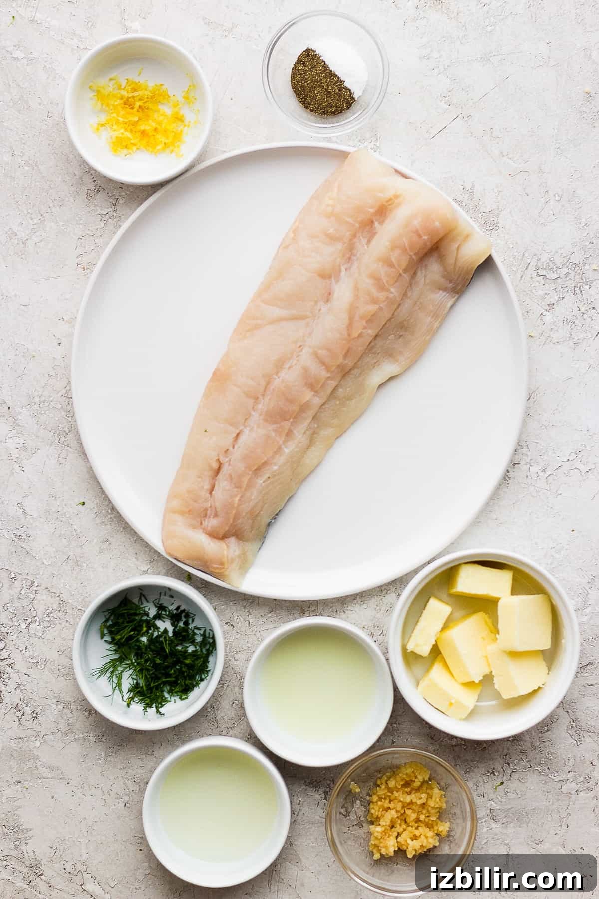 Grilled fish ingredients on a plate and in bowls.