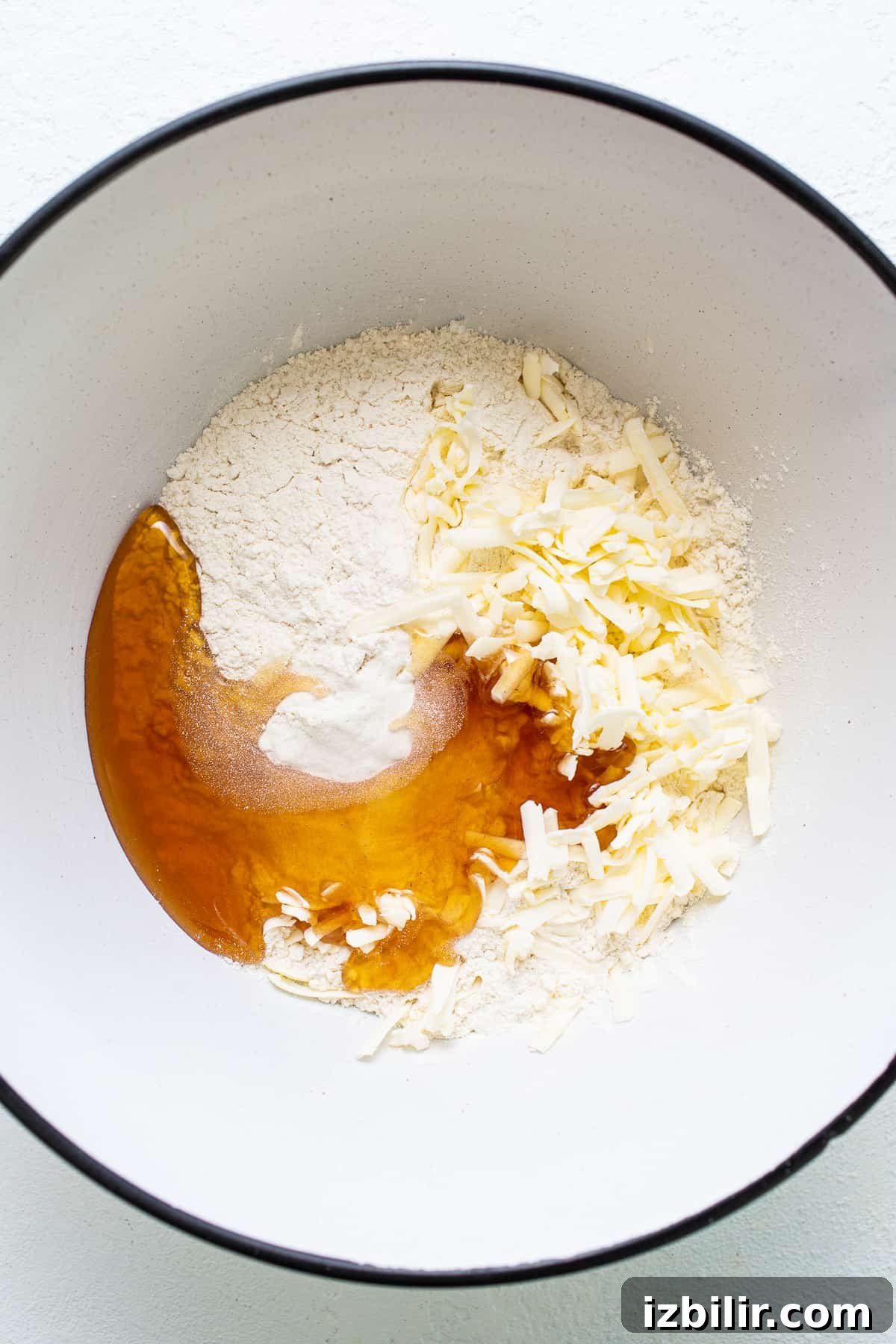 a white bowl filled with flour and other ingredients.