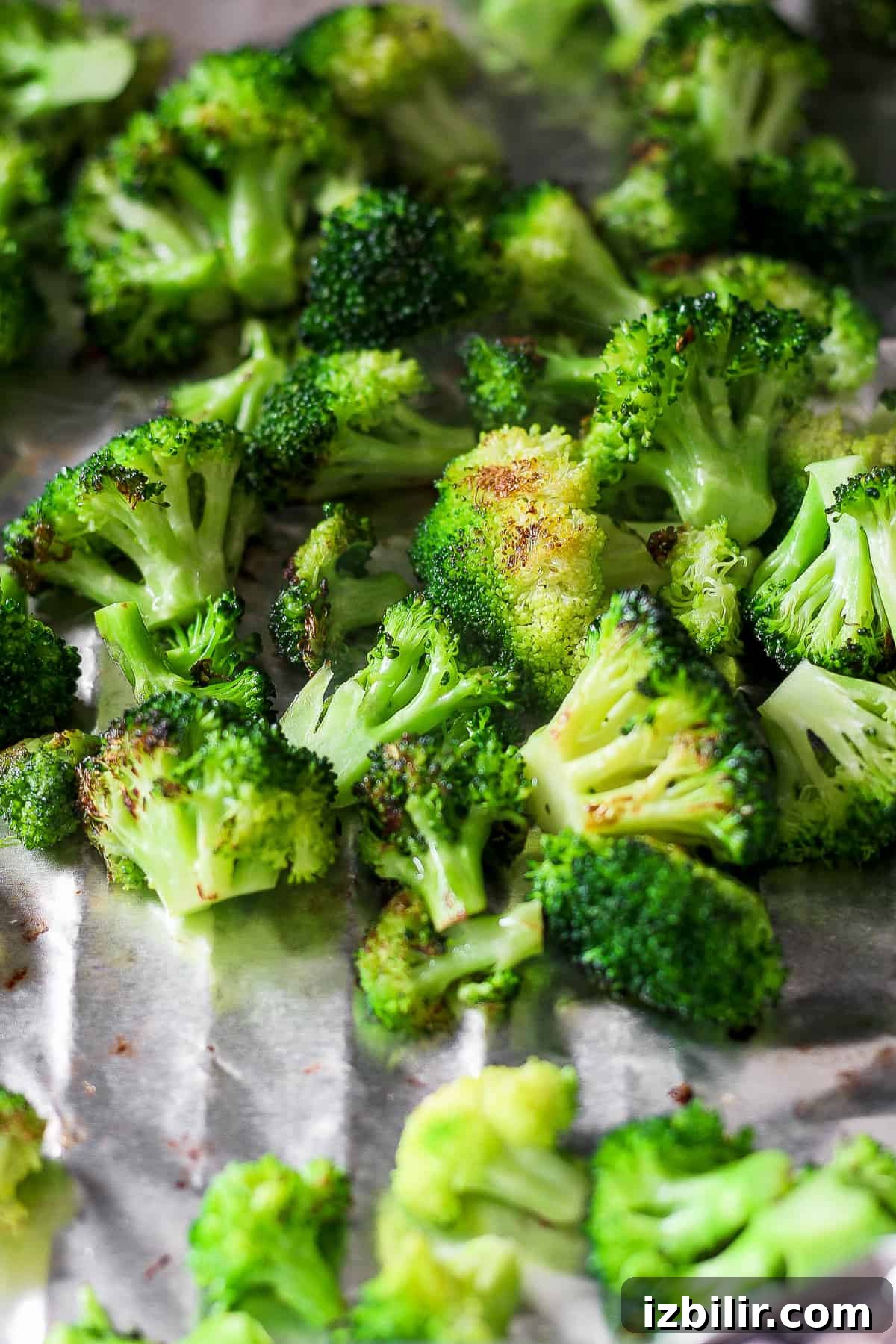 Smoky Grilled Broccoli with Garlic and Lemon 6 a bunch of broccoli sitting on top of a sheet of foil.