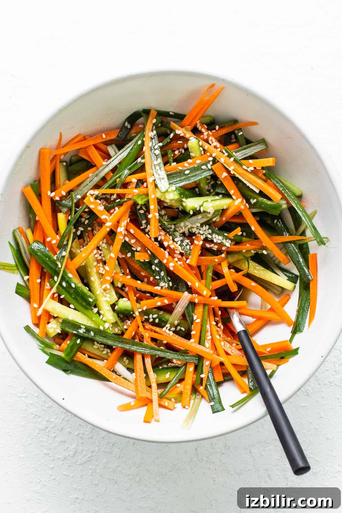 How to Make a Salmon Sushi Burrito at Home 3 a white bowl filled with carrots and green beans.