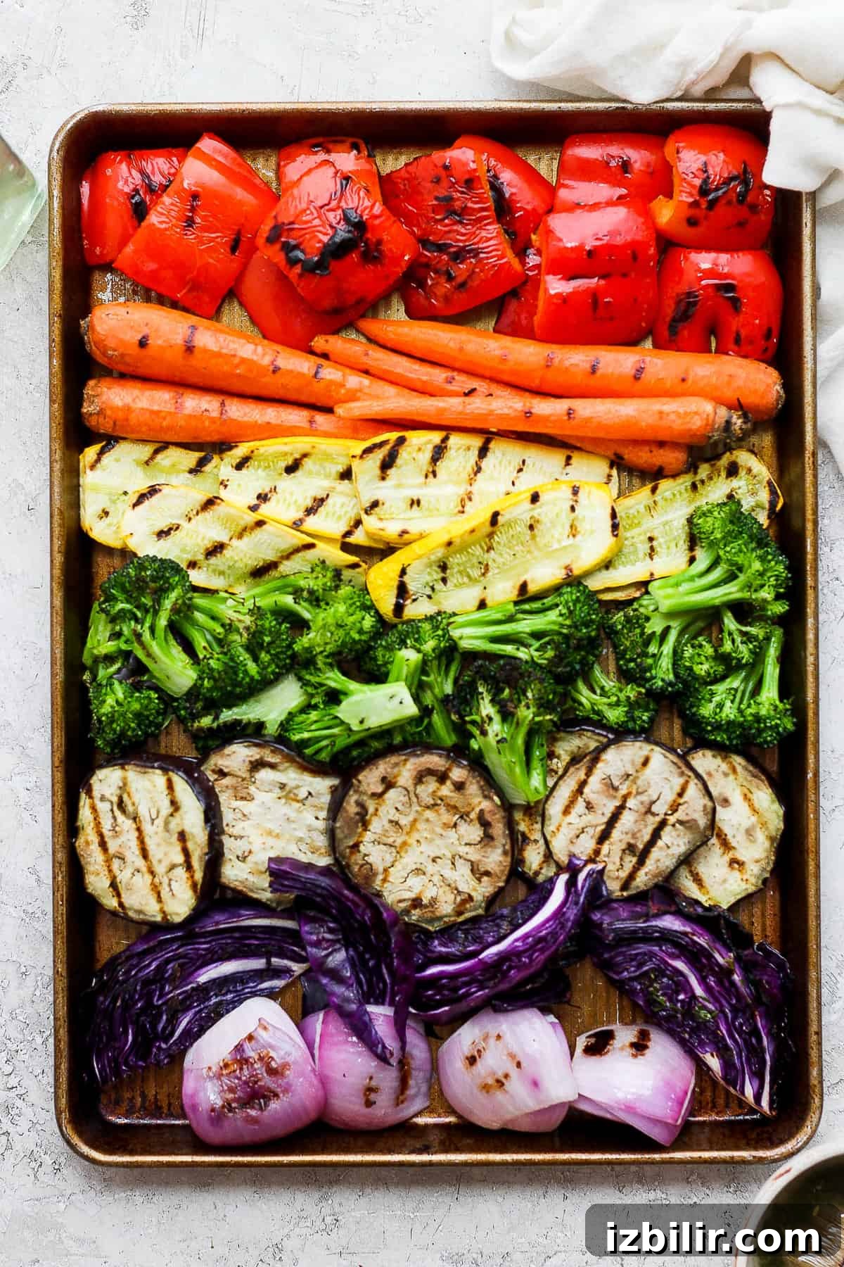 Grilled Rainbow Vegetables Recipe with Balsamic Glaze 2 A tray of grilled vegetables including carrots, broccoli, red onions.