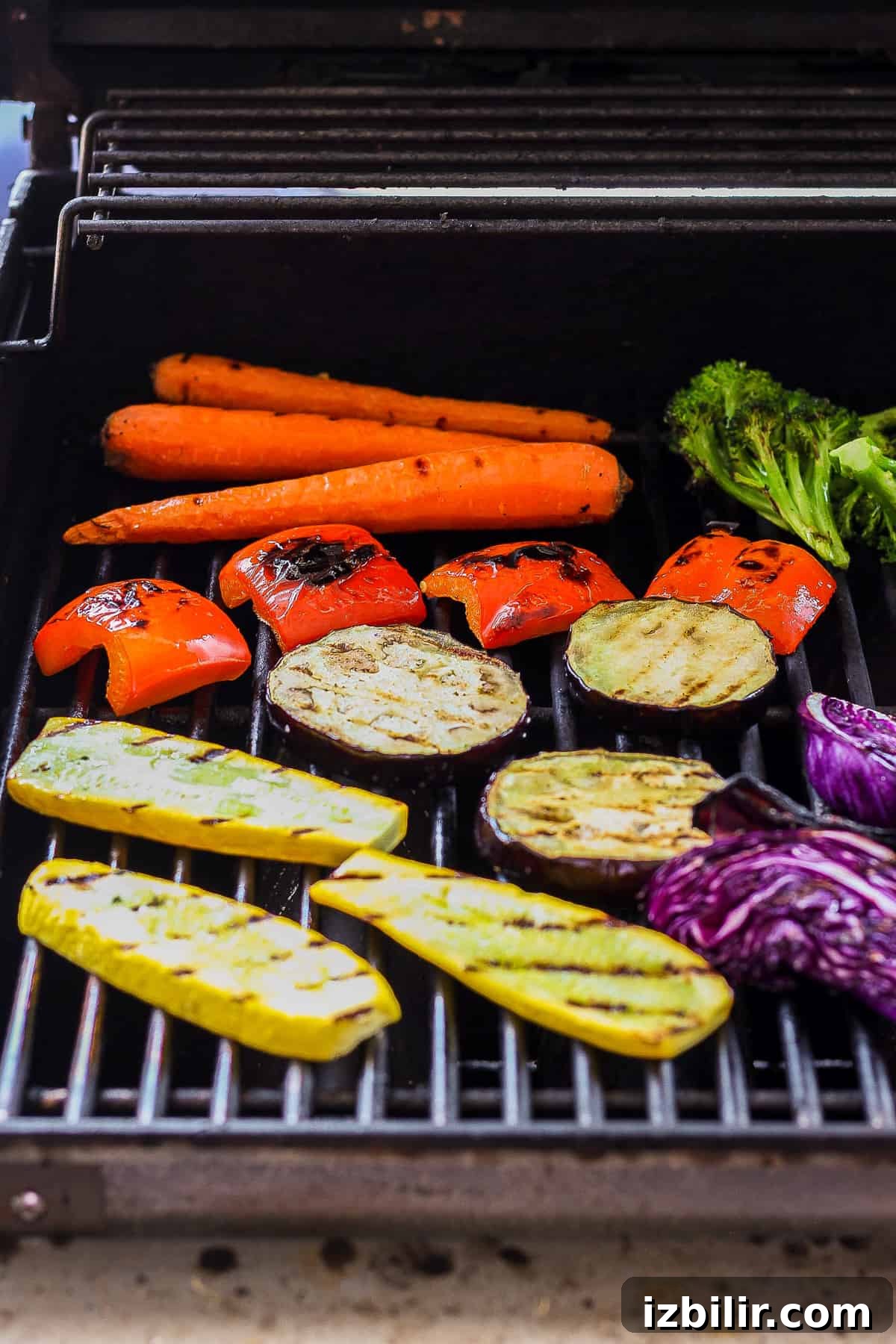 Grilled Rainbow Vegetables Recipe with Balsamic Glaze 5 A BBQ with carrots, broccoli, and other vegetables cooking on.