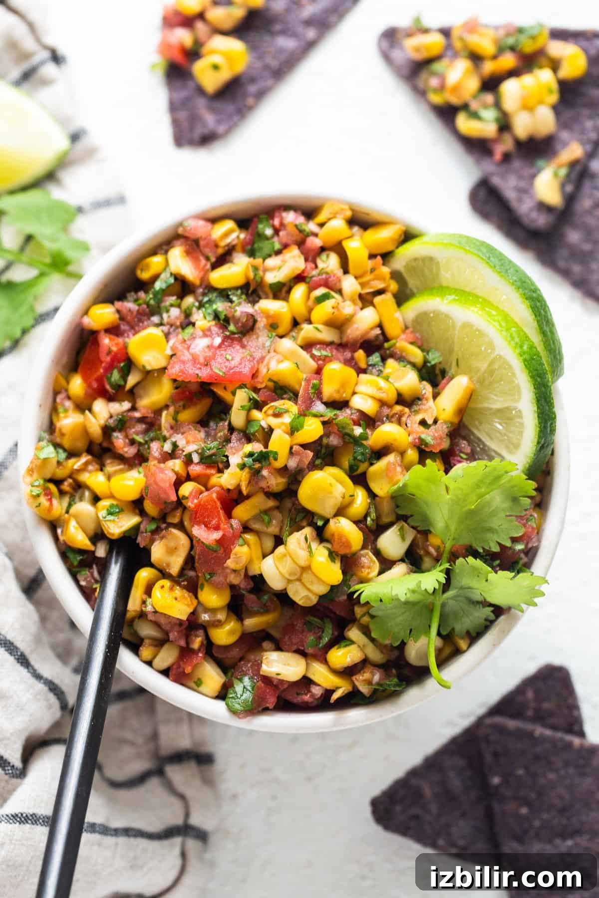 Mexican corn salad in a bowl with tortilla chips.