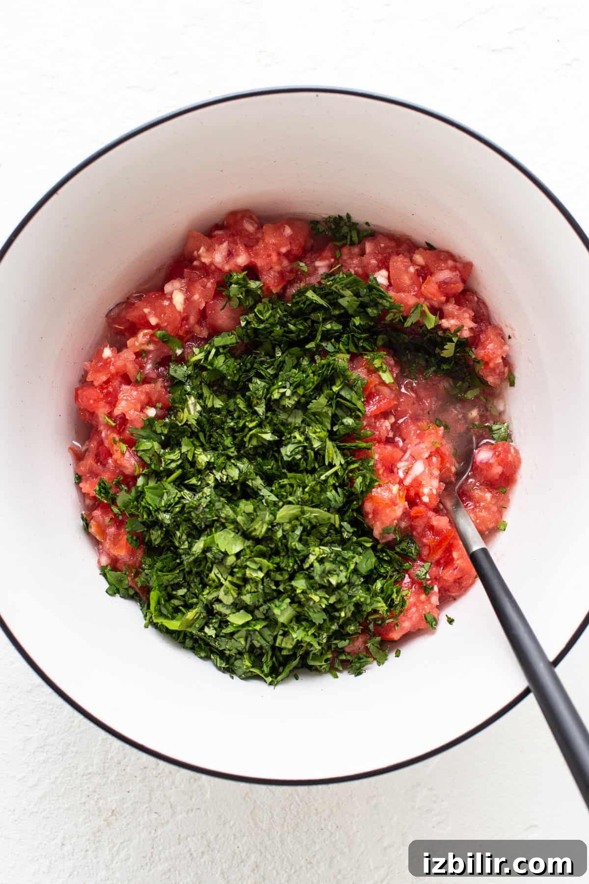 Bowl with tomatoes and herbs.