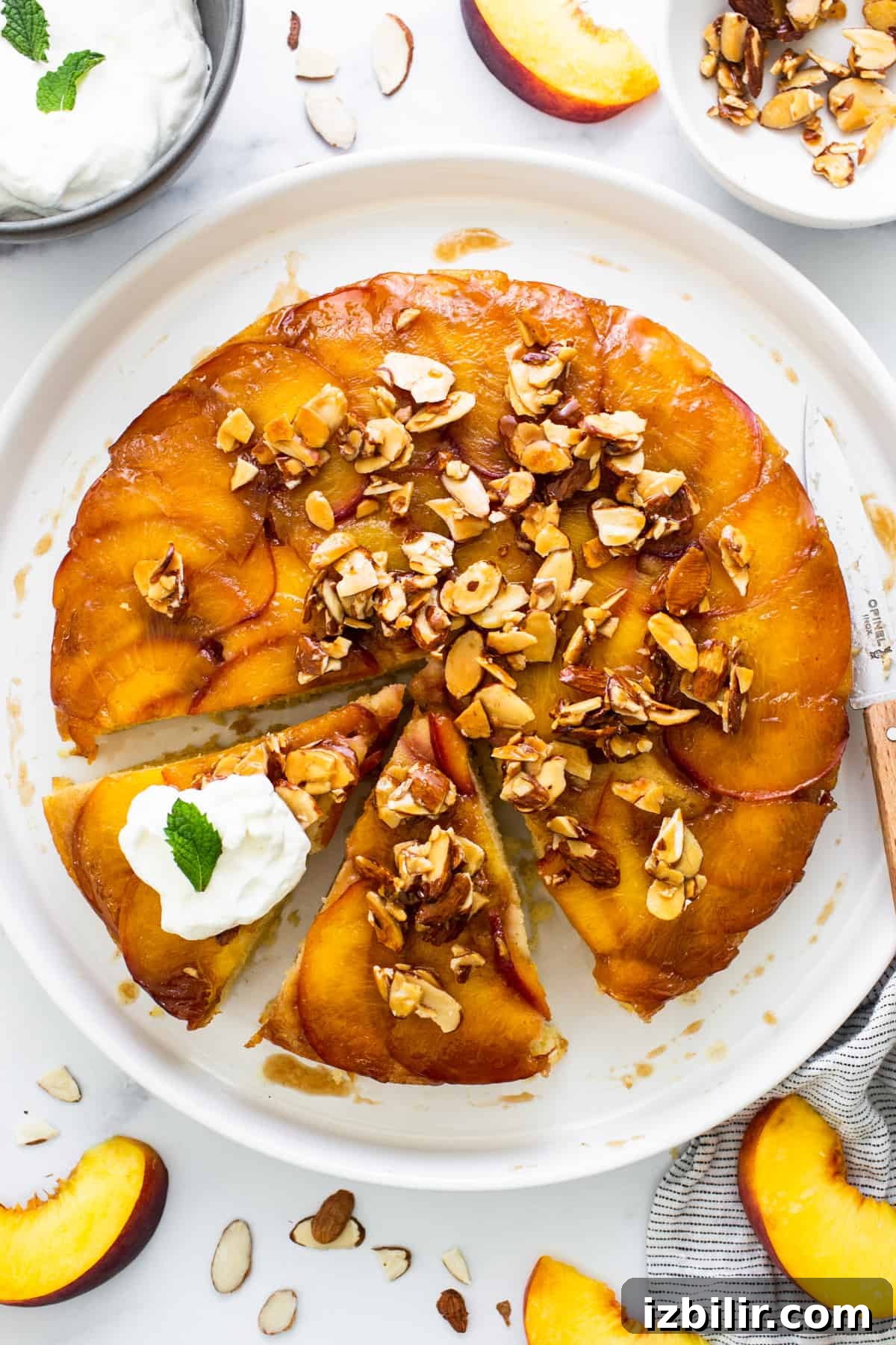 Caramelized Peach Upside Down Cake Recipe 6 A peach upside down cake on a plate with a slice taken out.