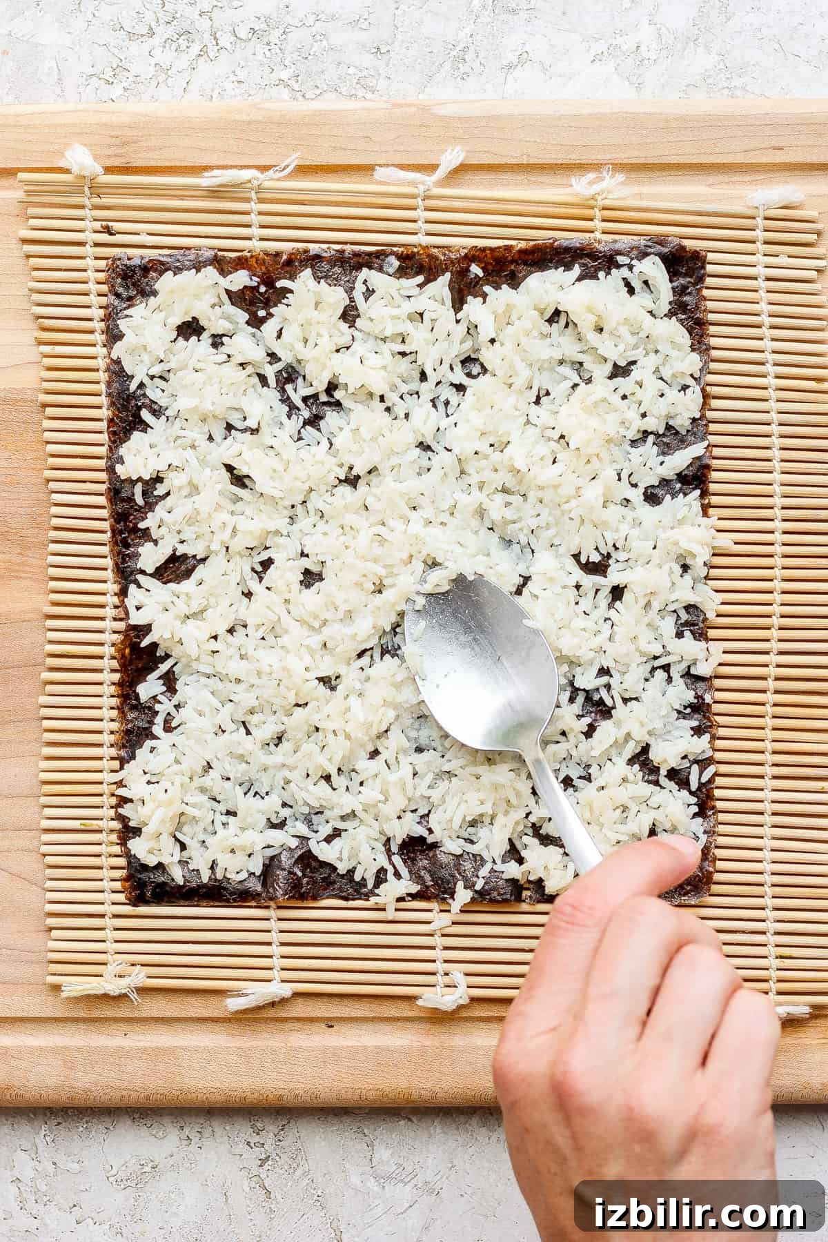 Spicy Tuna Roll Recipe: How to Make at Home 4 a person slicing a square of chocolate on a cutting board.