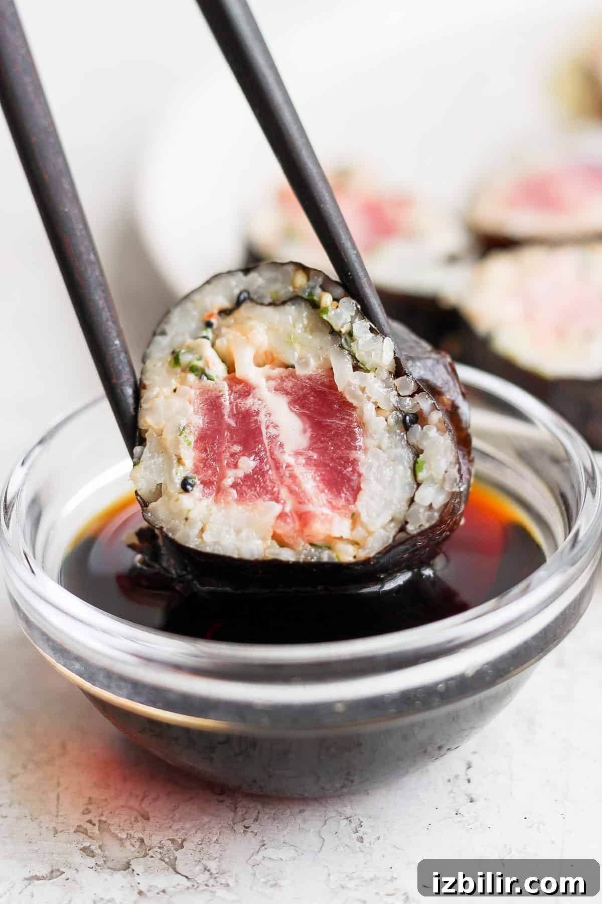 Spicy Tuna Roll Recipe: How to Make at Home 8 japanese tuna sushi in a bowl with chopsticks.