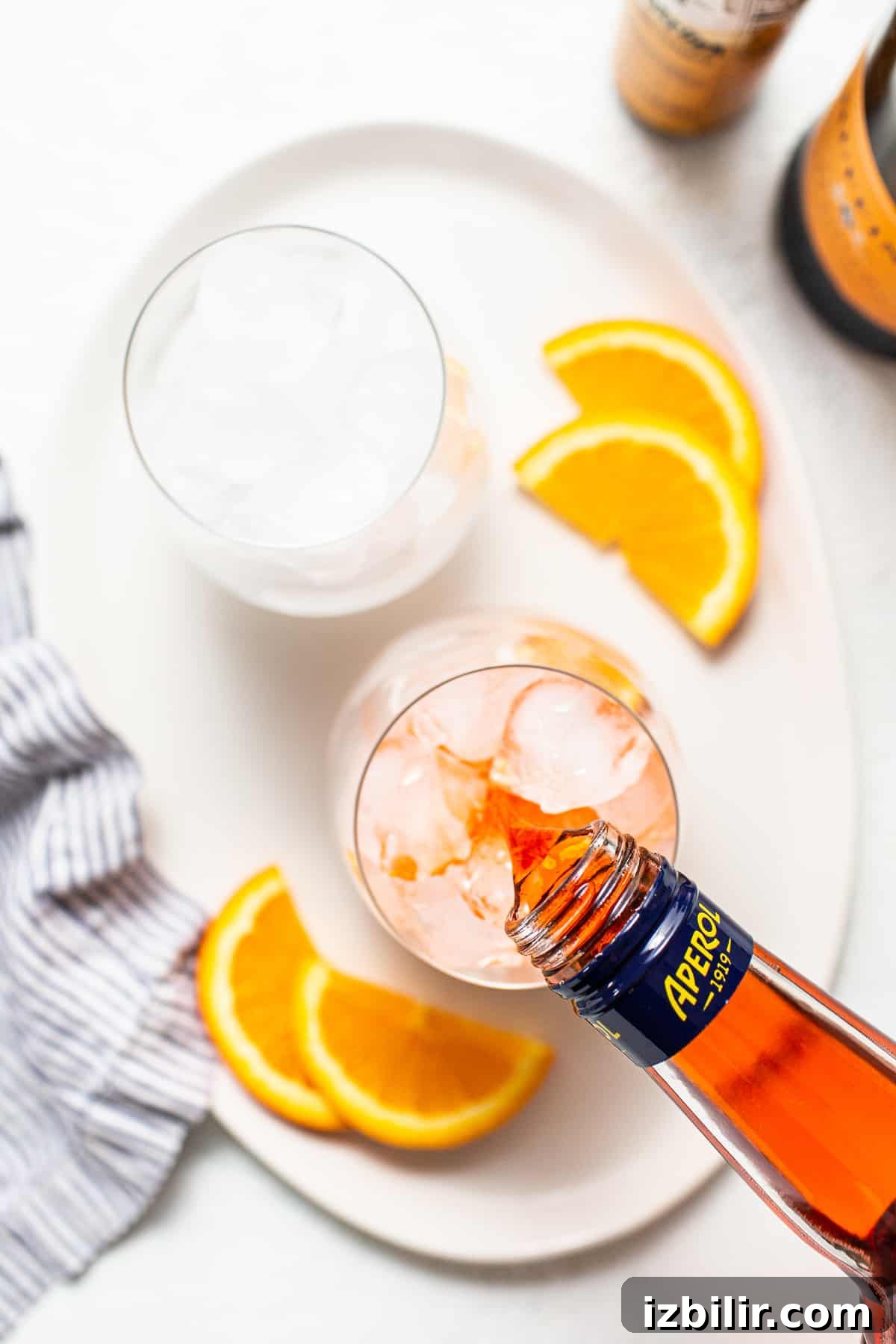 Aperol being poured into a glass.