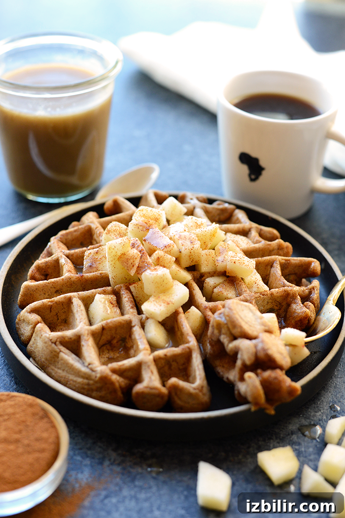 Stack of apple cinnamon waffles drizzled with caramel sauce