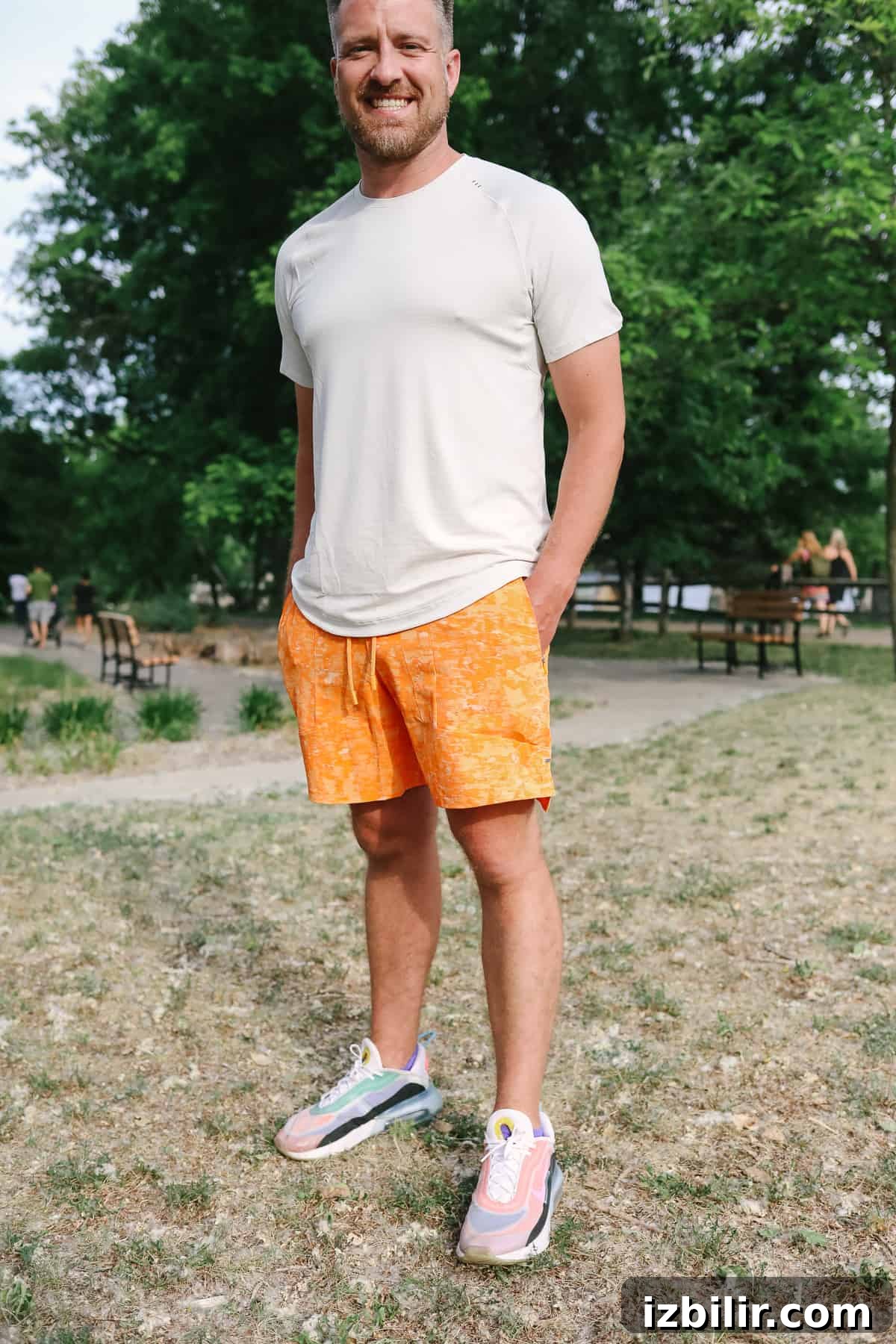 Man standing in a field wearing performance training shorts.