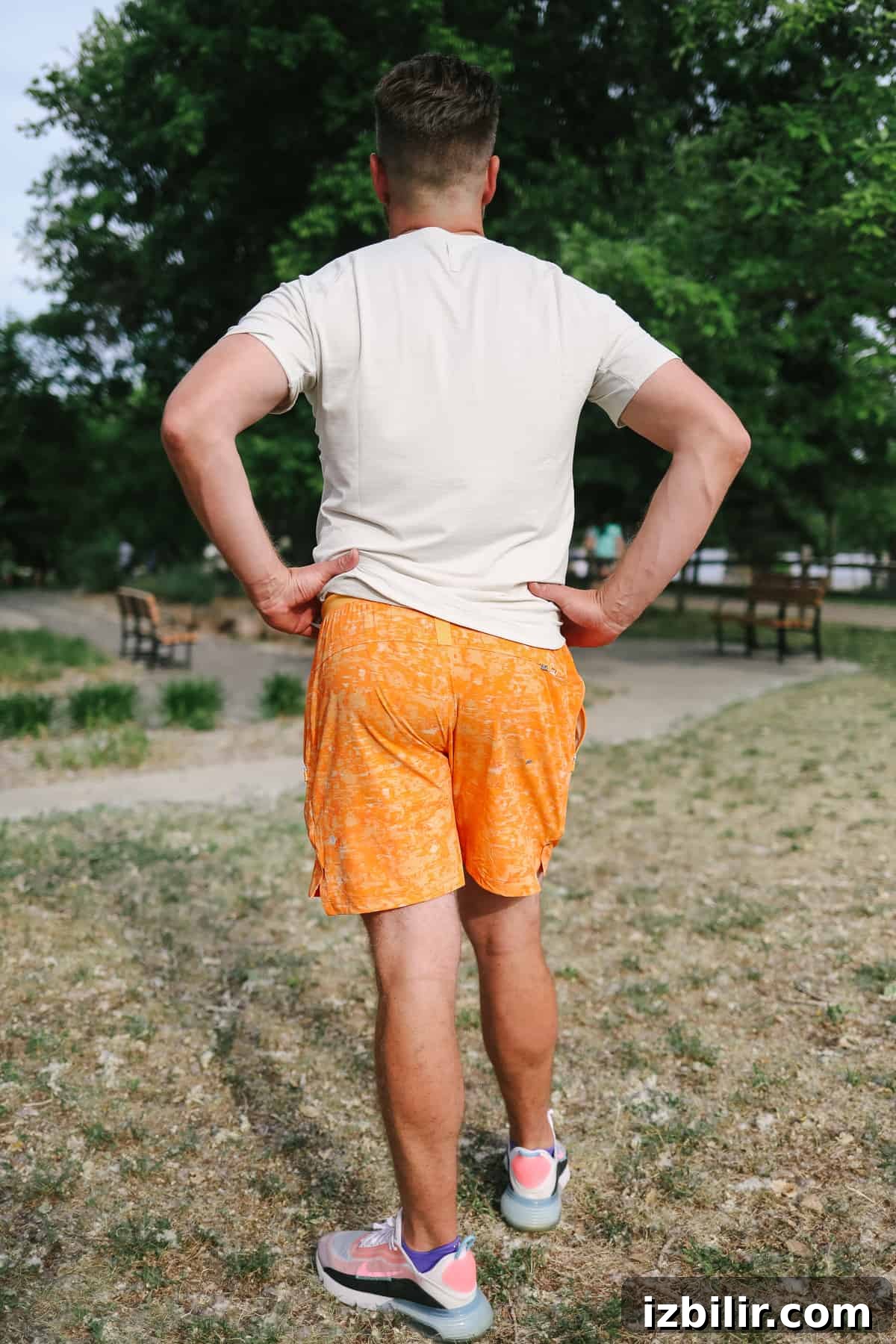 Back view of a man in athletic shorts outdoors.