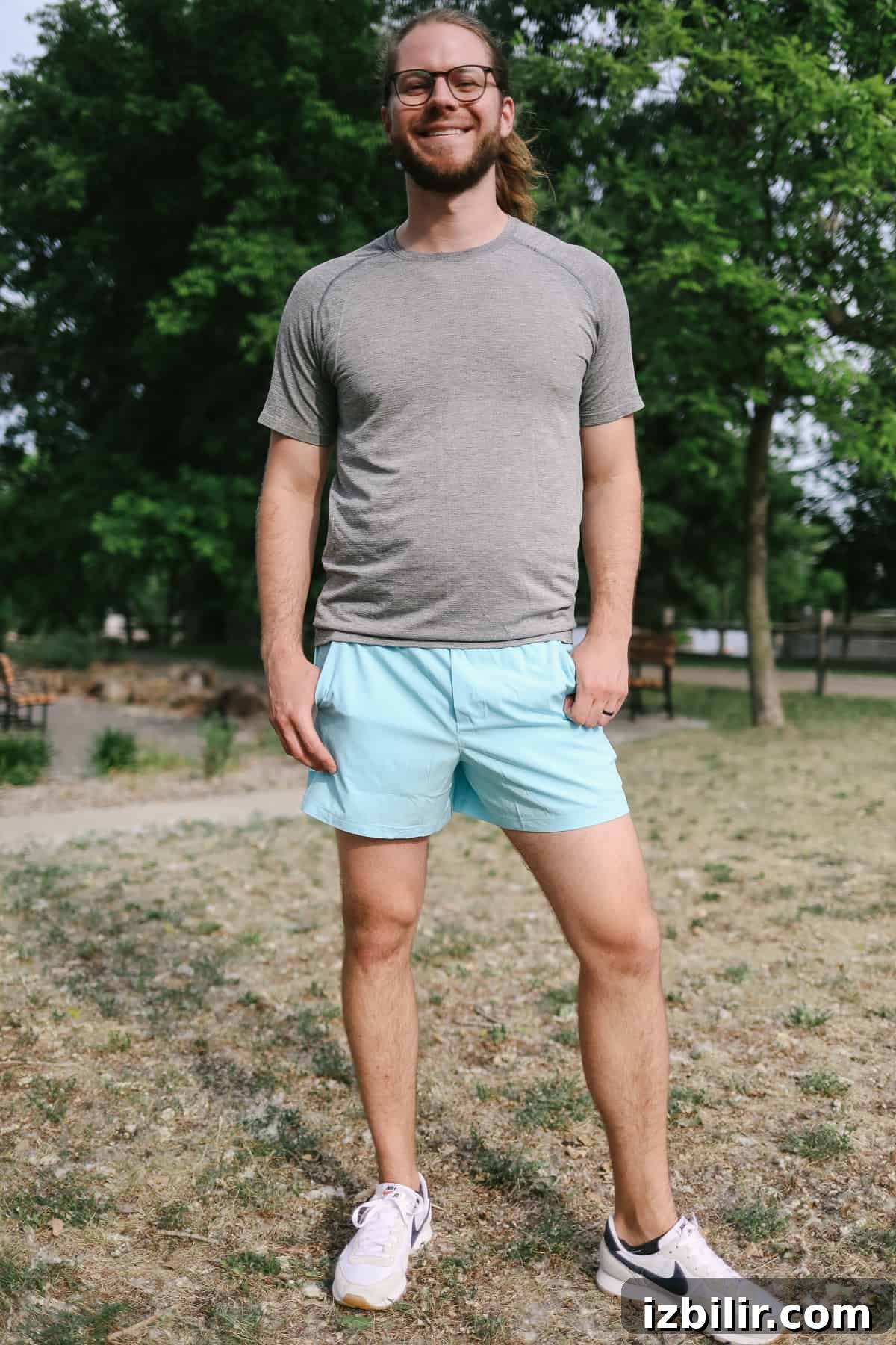 Man posing outdoors in shorts.