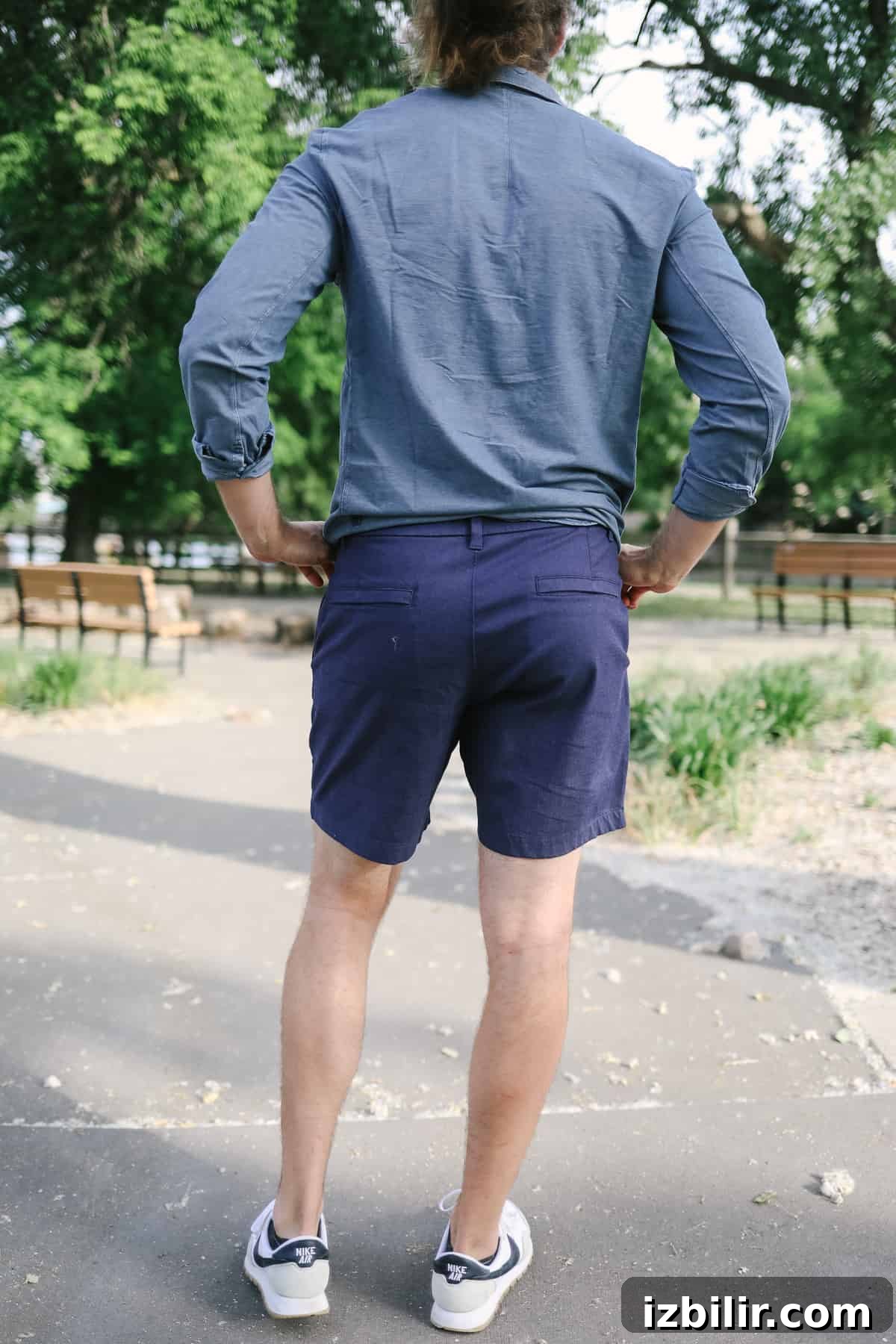 Man wearing blue shirt and blue shorts.
