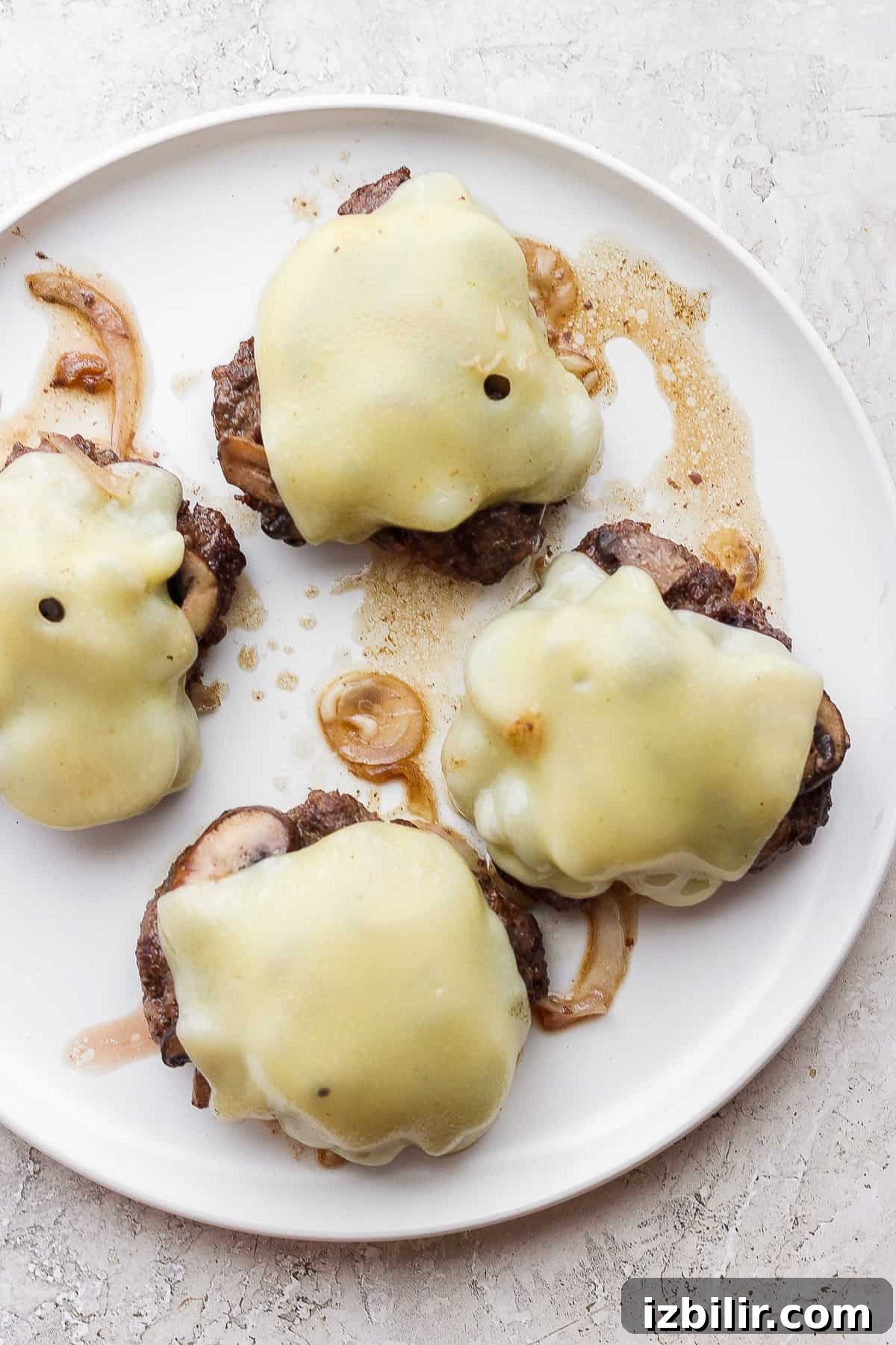 Grilled Mushroom Swiss Burger Recipe 6 four mushroom burgers on a plate with sauce.