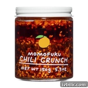 A jar of chili crunch on a white background.