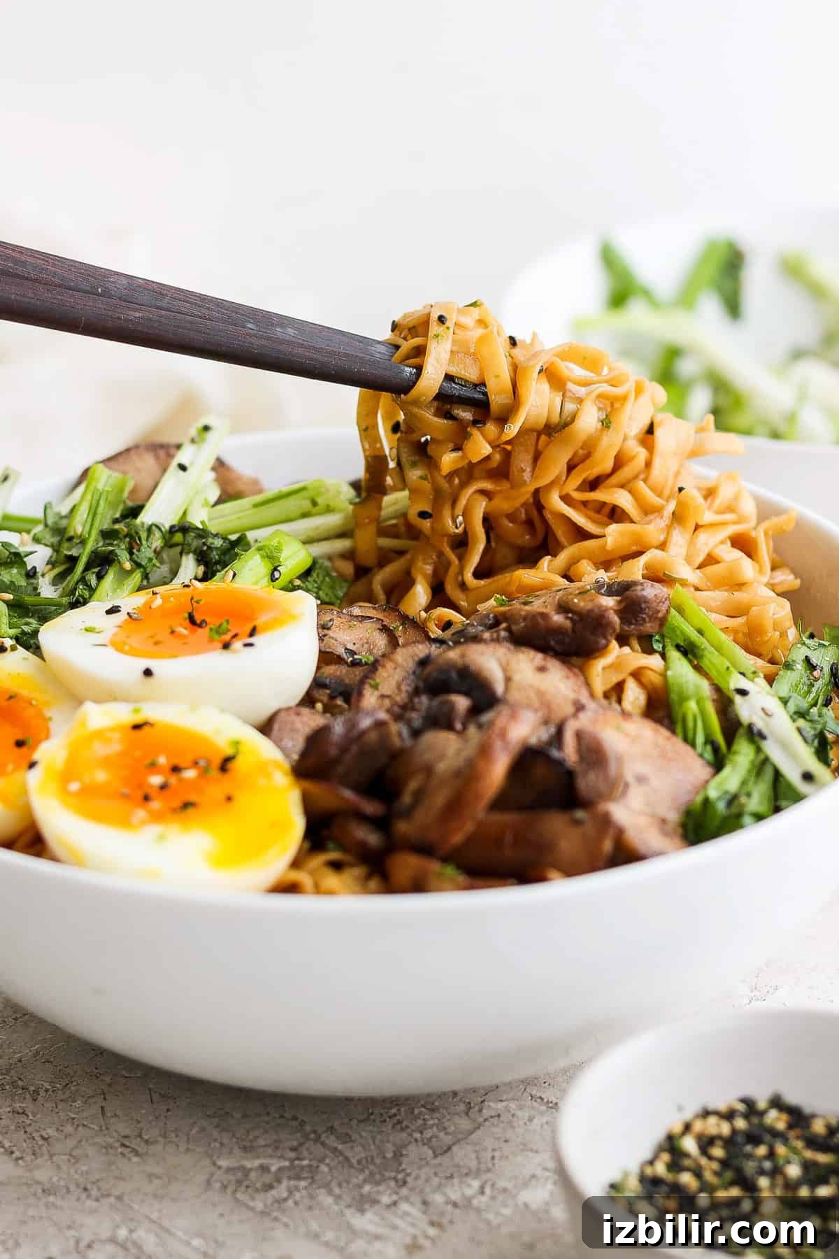 a bowl of asian noodle bowl with an egg and vegetables.