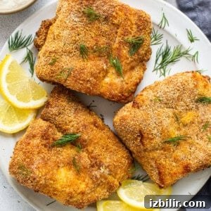 Air fryer fish on a plate.