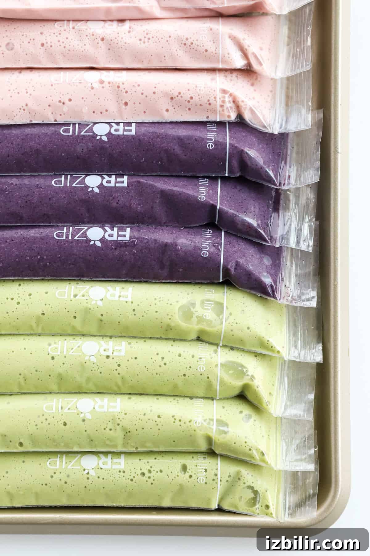 A tray filled with an array of colorful smoothies.