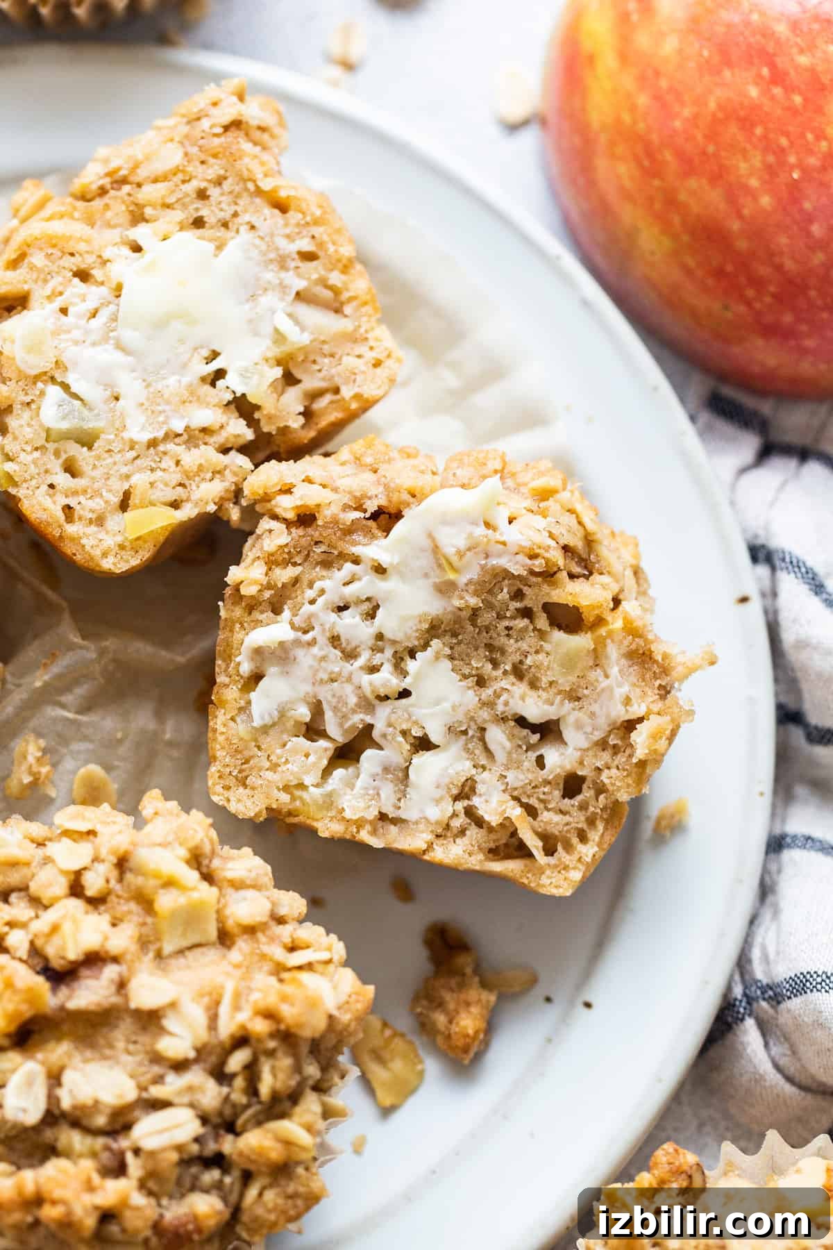 oatmeal apple muffins on a plate with apples.