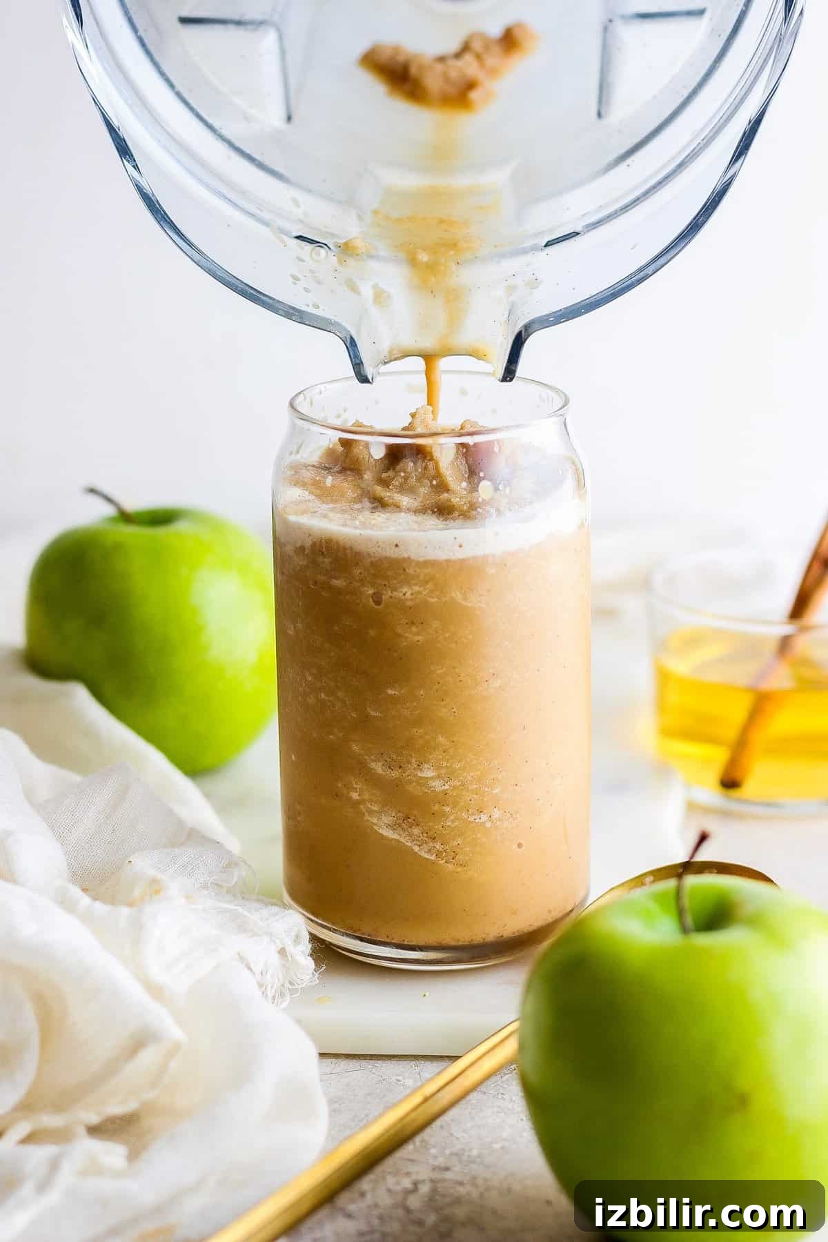 An apple juice being poured into a glass.