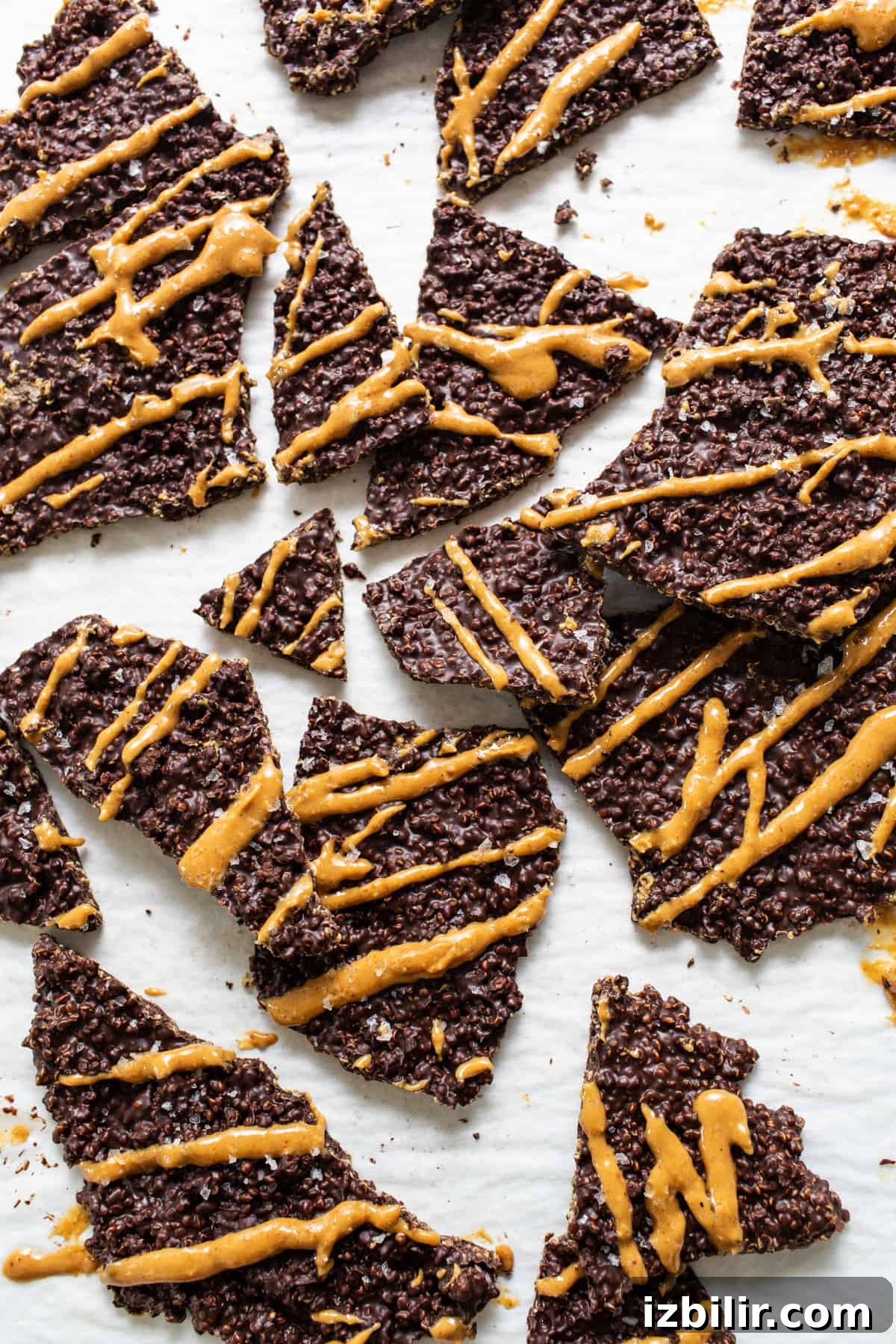 Crunchy Chocolate Quinoa Crisps Recipe 2 a pile of cookies with peanut butter drizzled on them.
