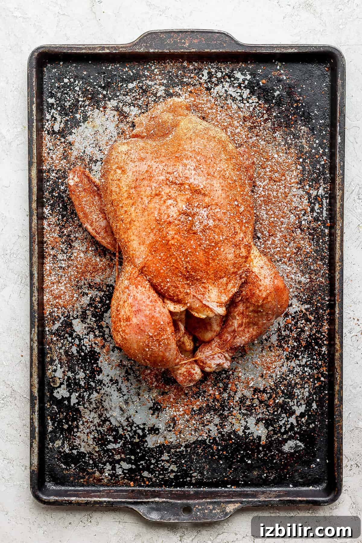 a roasted chicken on a baking sheet.