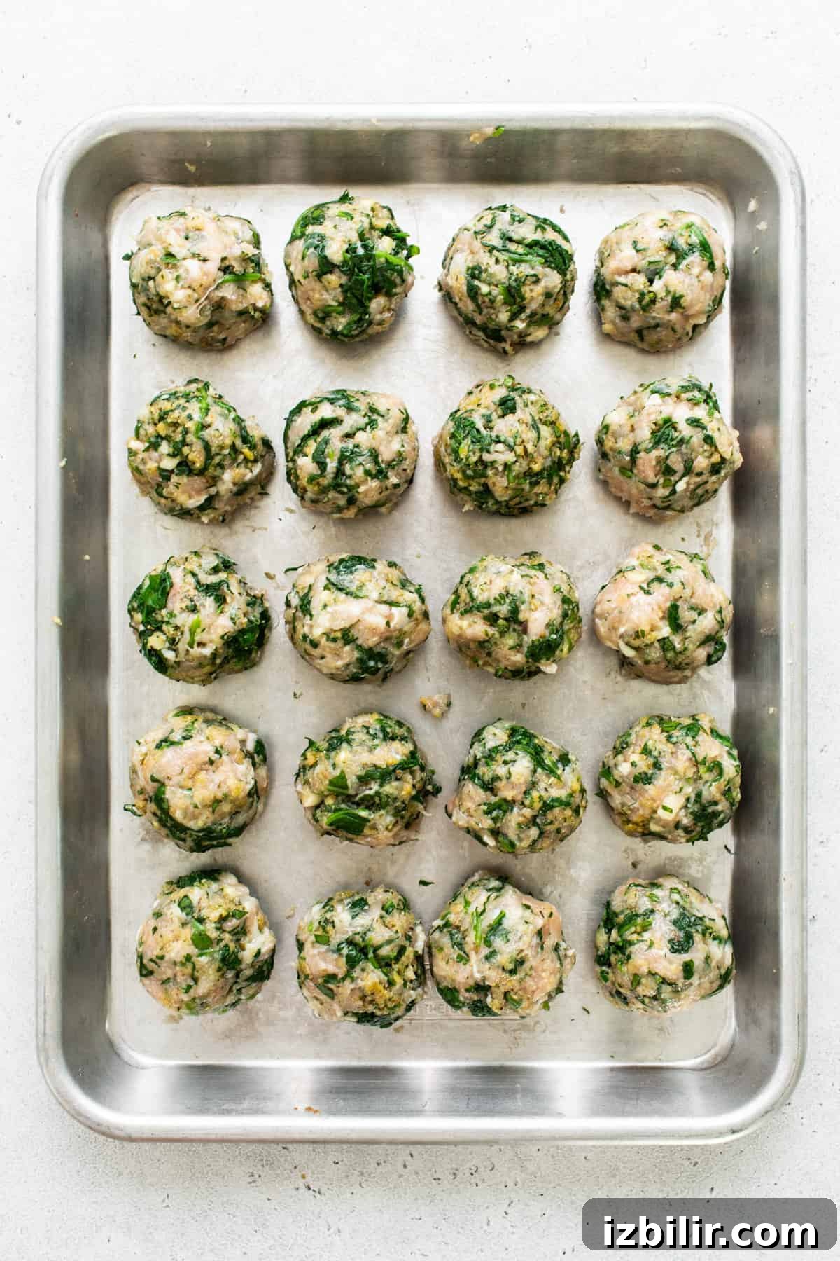 Spinach and mushroom meatballs on a baking sheet.