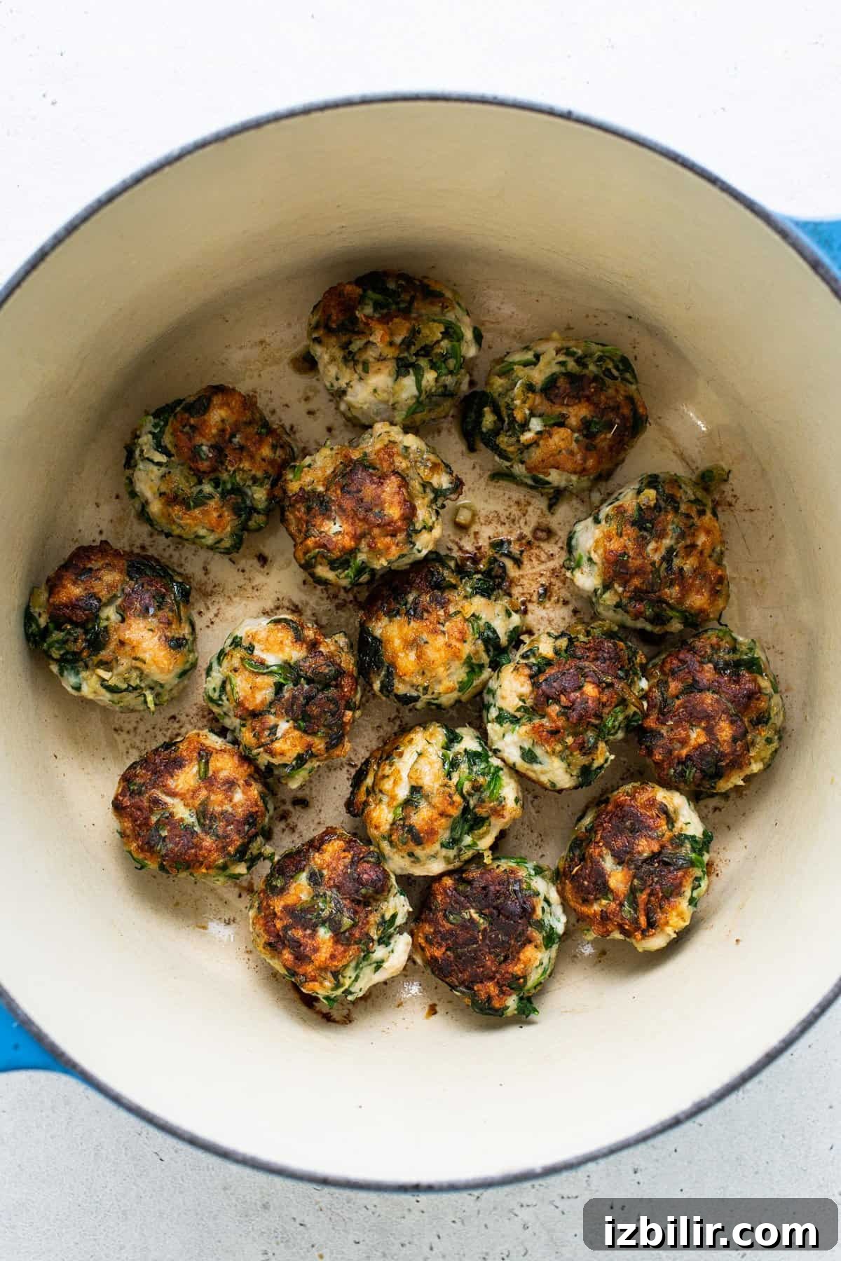 Chicken and spinach croquettes in a blue pot.