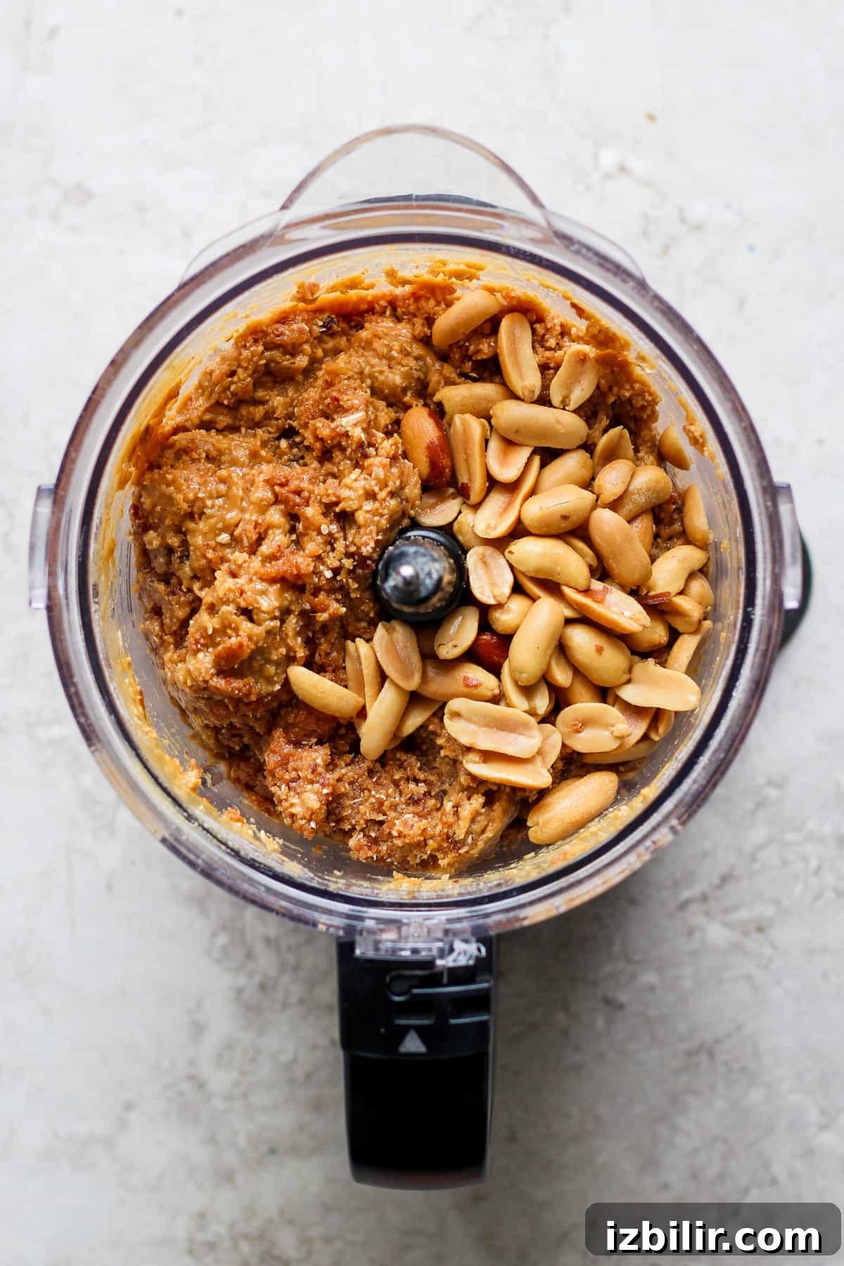 September 2023 Fit Foodie Cooking Club: Seasonal Recipes 5 a food processor filled with peanuts and other ingredients.
