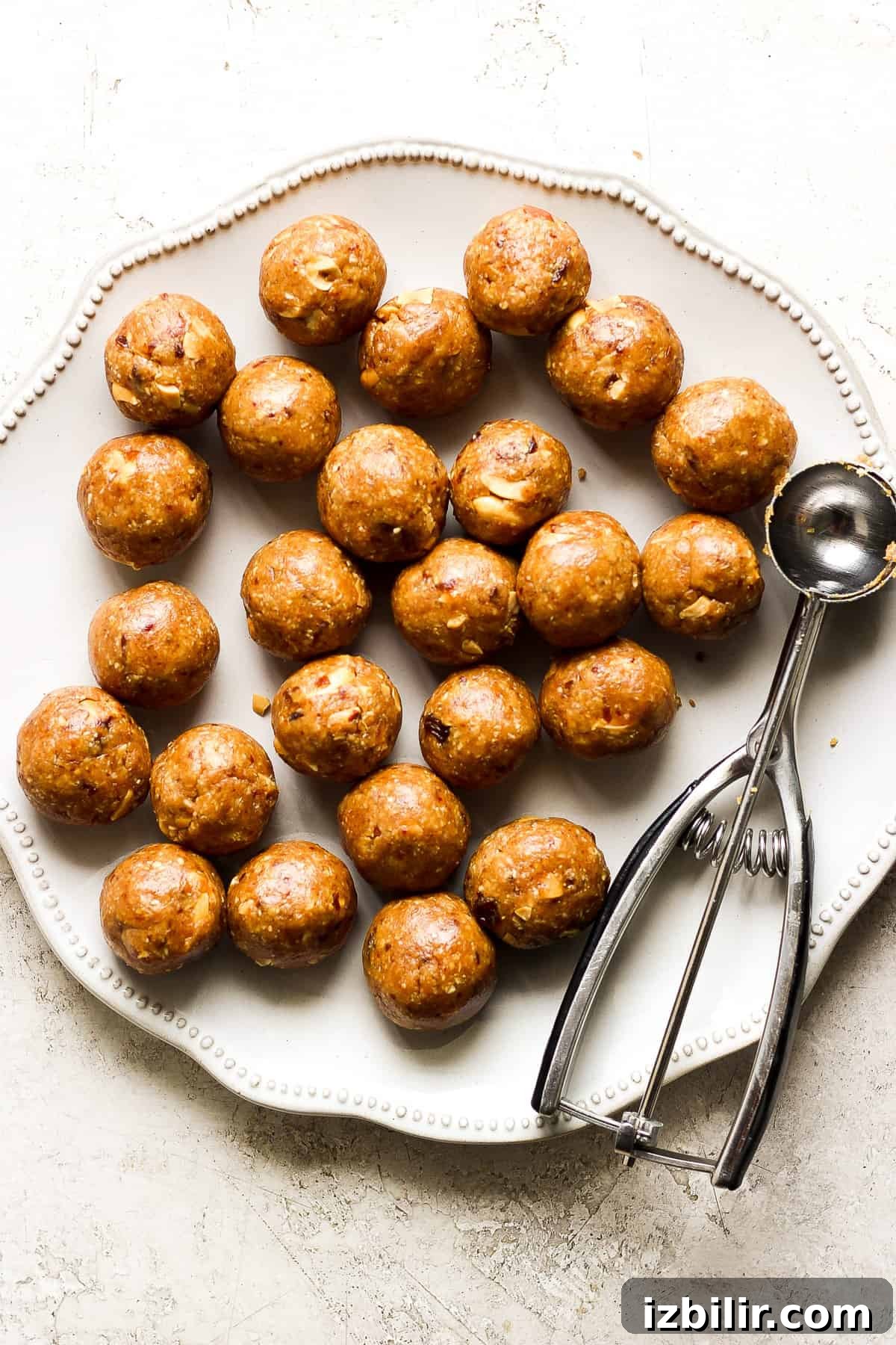 September 2023 Fit Foodie Cooking Club: Seasonal Recipes 6 peanut butter balls on a plate with a spatula.