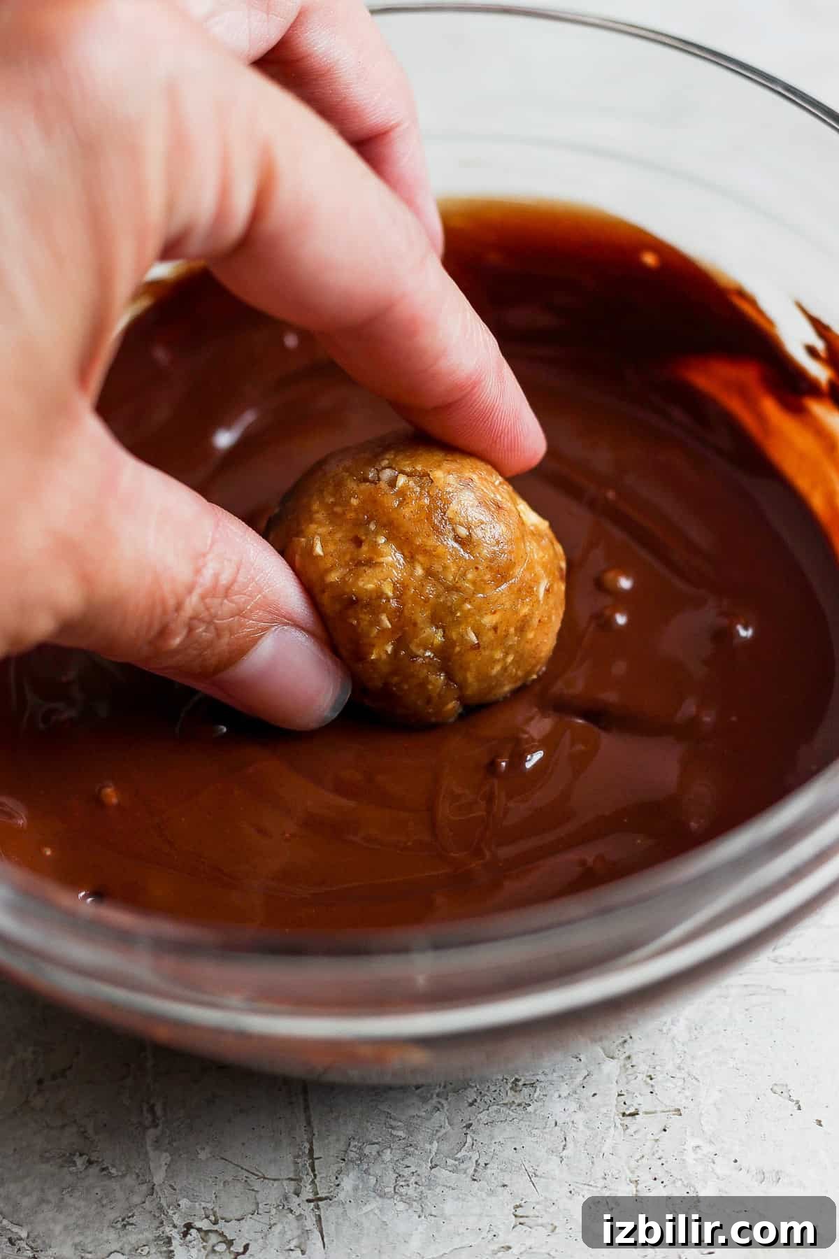 September 2023 Fit Foodie Cooking Club: Seasonal Recipes 7 a person dipping a doughnut into chocolate sauce.