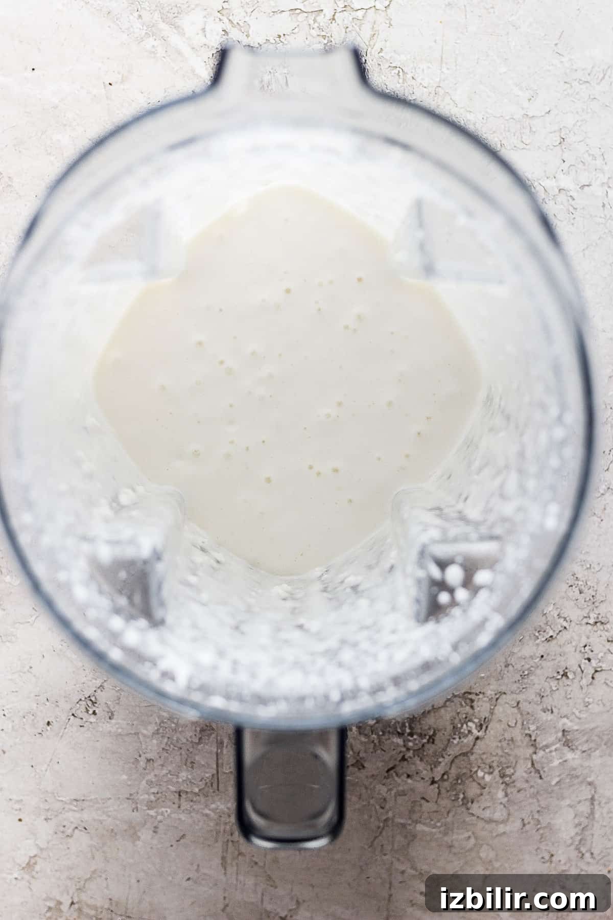 A blender with a white liquid in it.