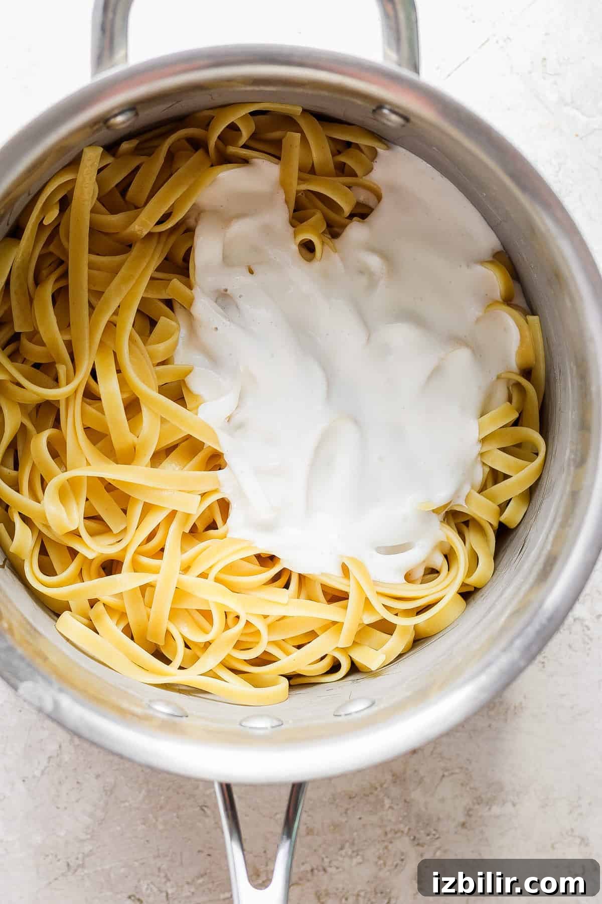 A pot of pasta with cream in it.