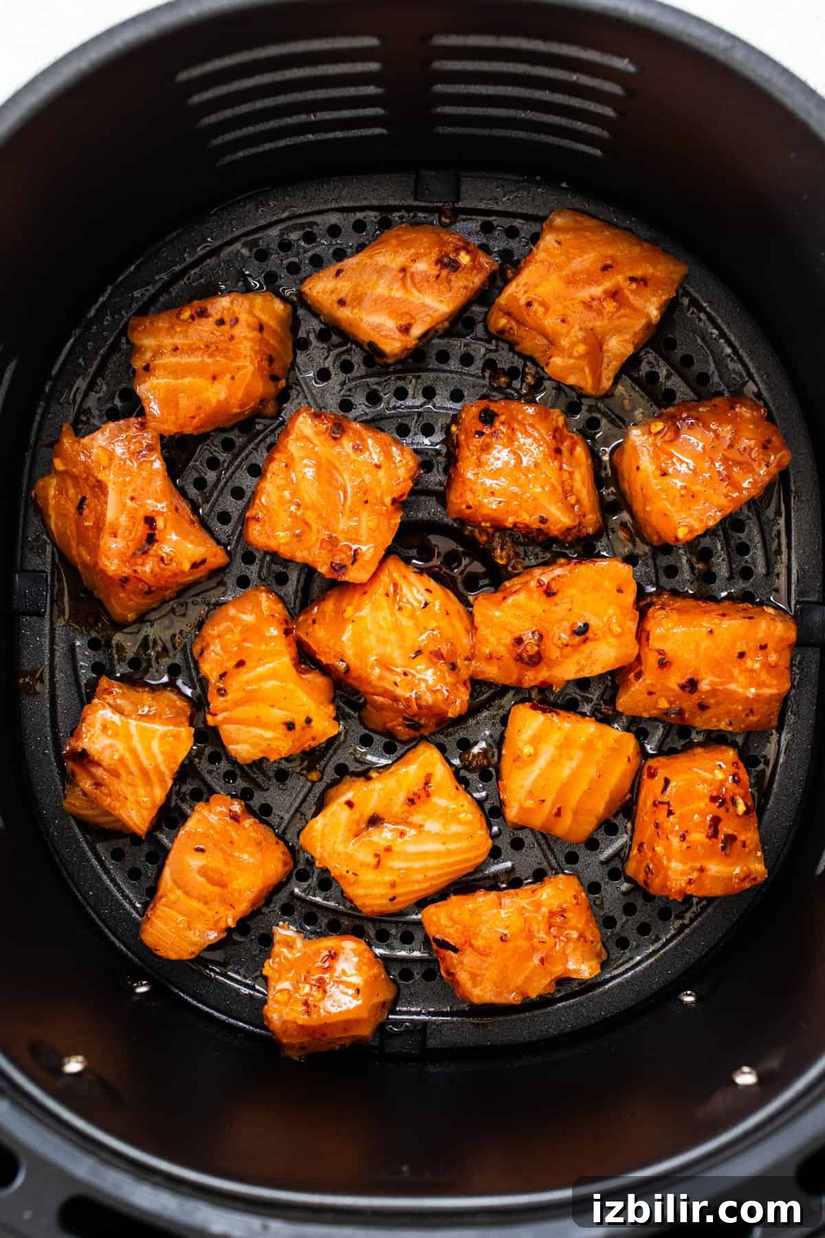 Crispy Air Fryer Honey-Chili Crunch Salmon Bites 5 Salmon bites cooking.
