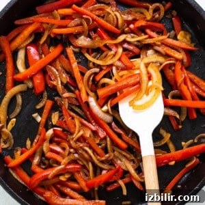 Korean Beef Bulgogi Rice Bowl Recipe 6 A skillet filled with red peppers and onions.